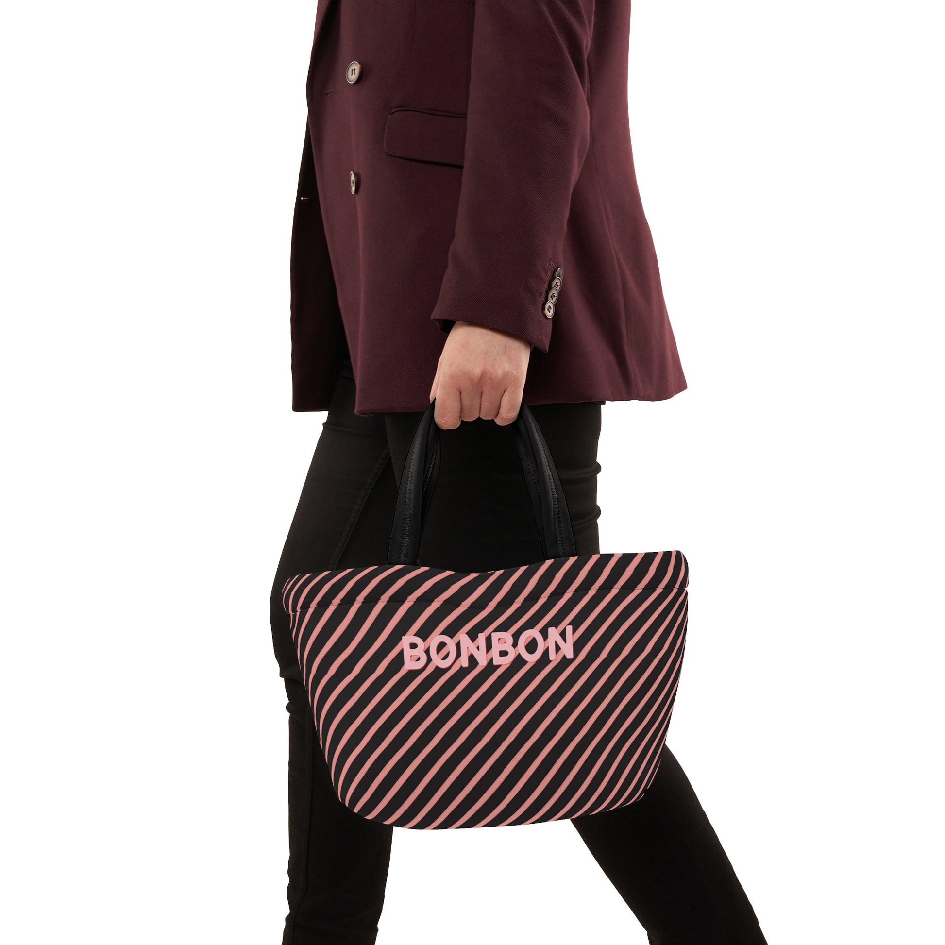 Person holding a striped bag with 'BONBON' branding against a white background