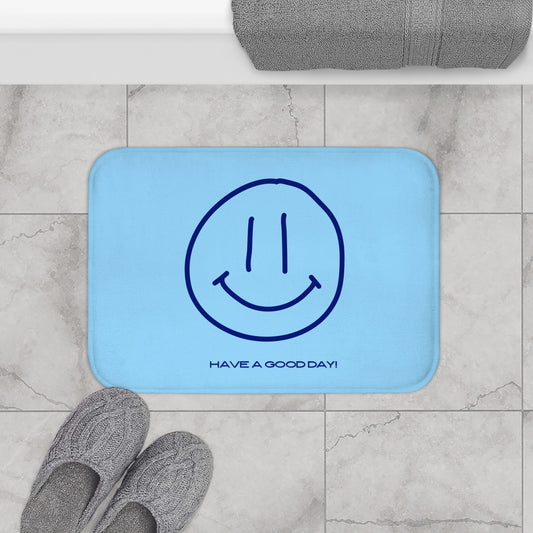 Blue mat with smiley face design and text 'Have a good day!' on a tiled floor.