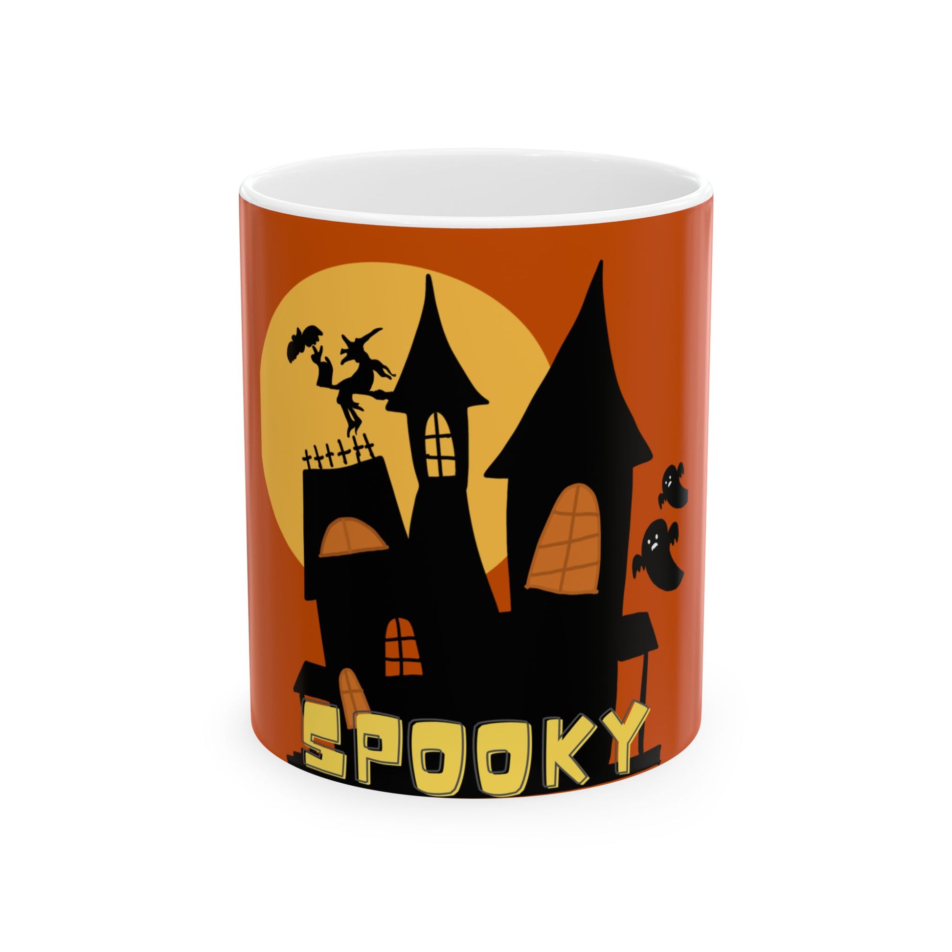 A white ceramic mug featuring a Halloween-themed graphic print with a black haunted house silhouette, a witch on a broomstick, flying ghosts, and the word 'SPOOKY' in yellow text against an orange and yellow background.
