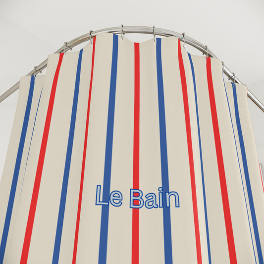 Striped shower curtain with red, blue, and white vertical stripes and 'Le Bain' text on a beige background.