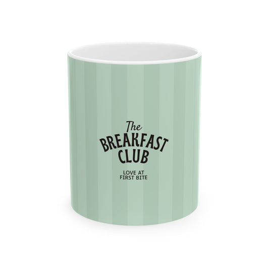 A mint green ceramic mug with vertical stripes and black text reading 'The Breakfast Club' and 'LOVE AT FIRST BITE', shown on a plain white background.