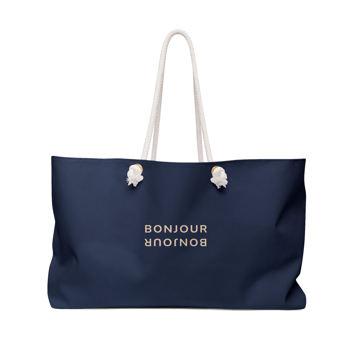 A navy blue tote bag with white rope handles and white shell-shaped ring pulls, featuring the word 'BONJOUR' printed in gold on the front, set against a plain white background.