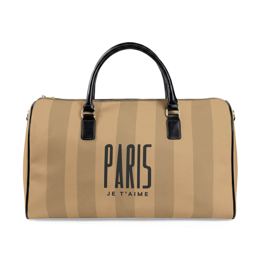 A beige and tan vertically striped duffle bag with black leather handles and trim, featuring the text 'PARIS JE T'AIME' printed in black on the front.