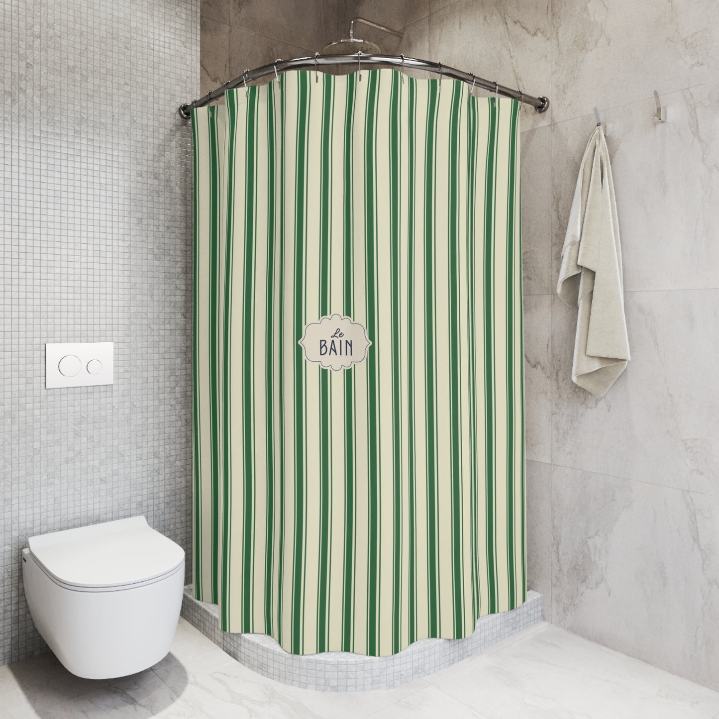 A green and cream striped bath curtain hanging in a modern bathroom with gray tiled walls, a white toilet, and a folded towel.