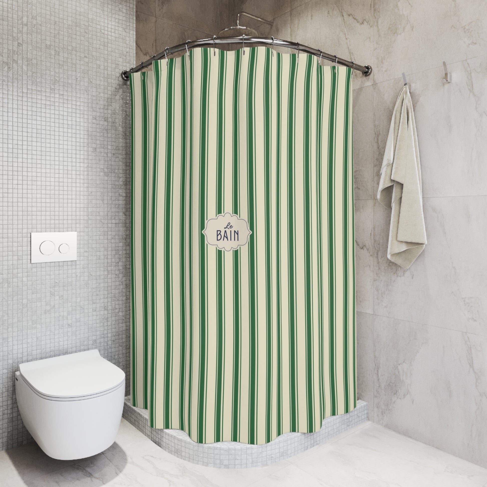A green and cream striped bath curtain hanging in a modern bathroom with gray tiled walls, a white toilet, and a folded towel.