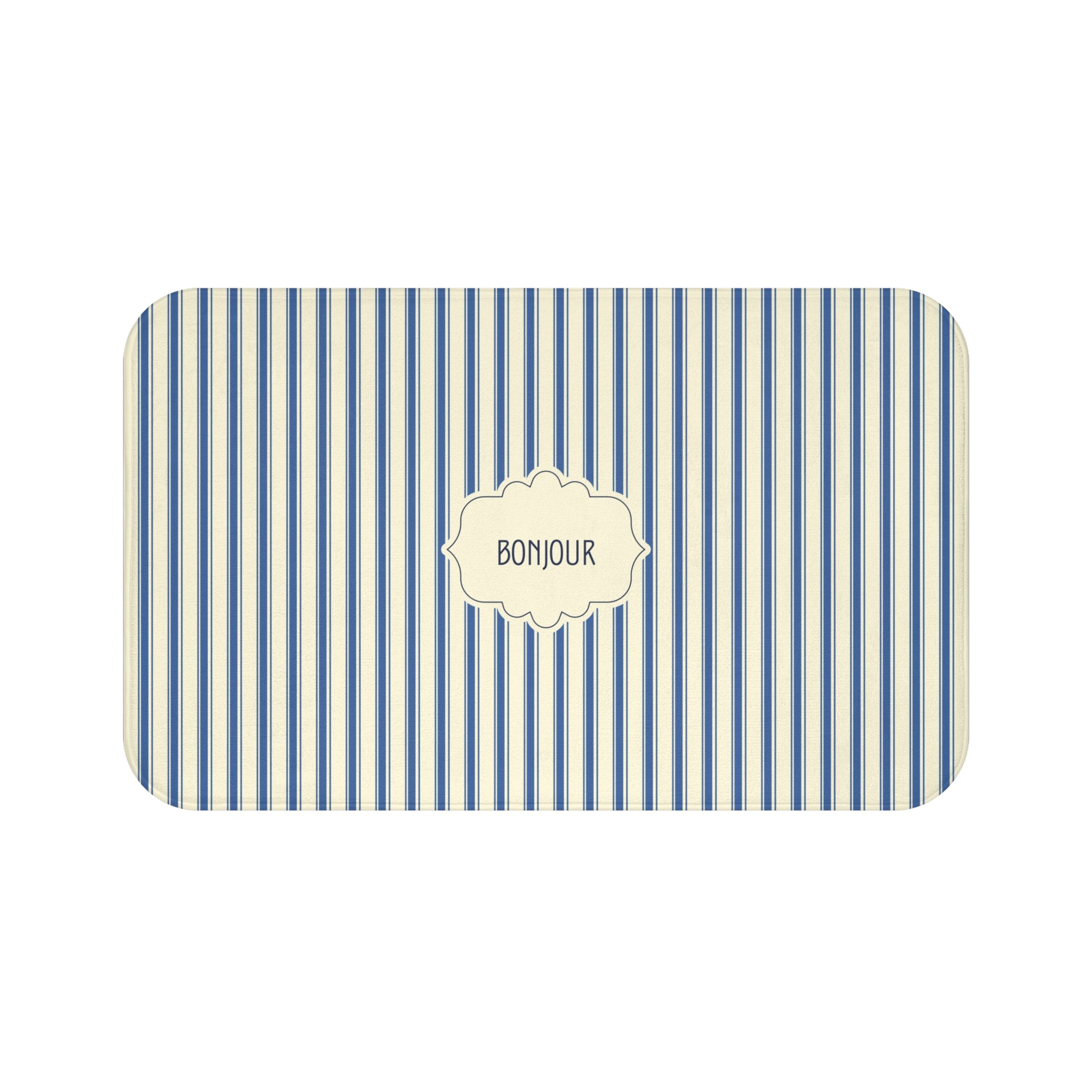 A luxury bath mat with rounded corners, featuring vertical blue and cream stripes and a central cream label with the word 'BONJOUR'.