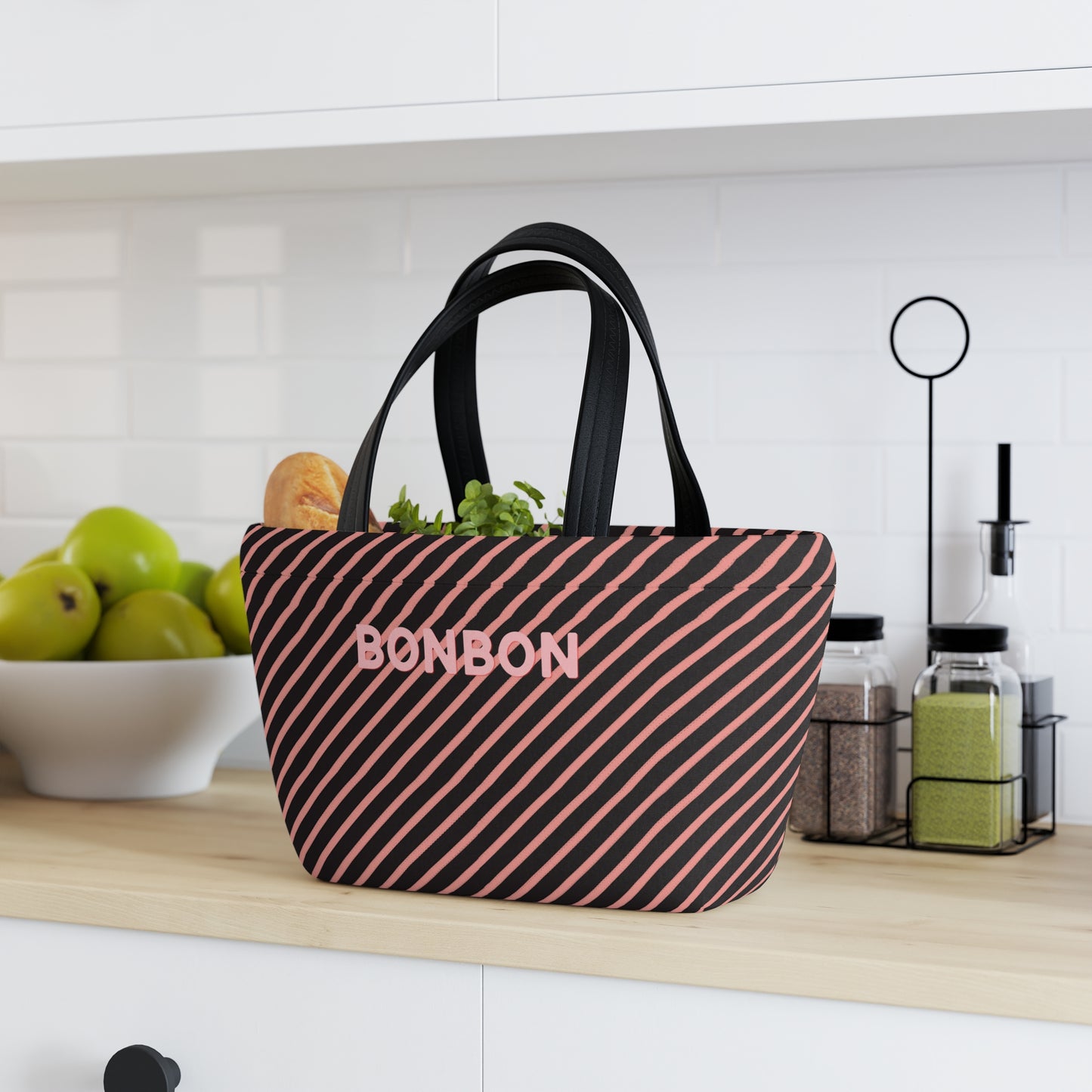 Black and pink striped bag with 'BONBON' branding on a kitchen counter.