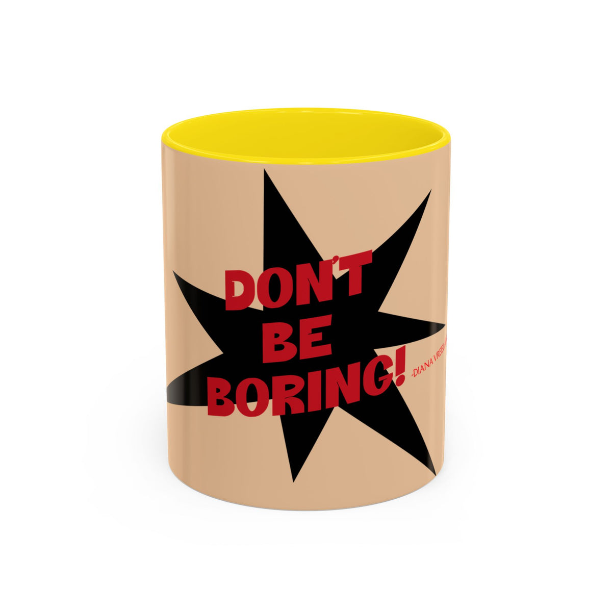A ceramic mug with a beige exterior, a bright yellow interior, and a black starburst graphic on the front featuring the red text 'DON'T BE BORING!'.