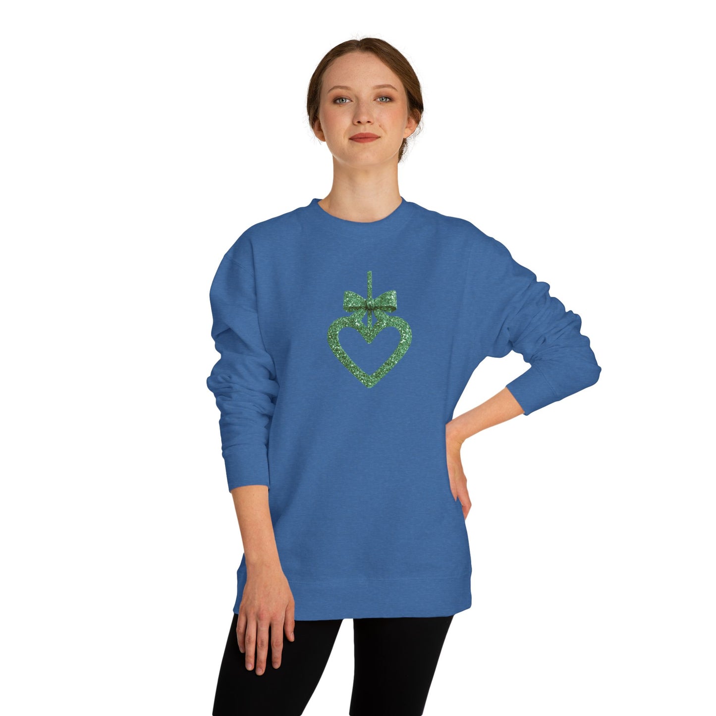 Woman wearing a blue sweatshirt with a green heart design on a white background