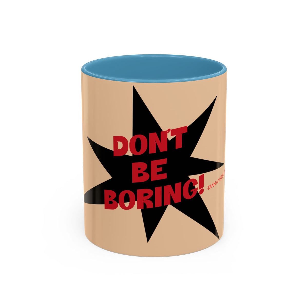 A ceramic mug with a tan exterior, a blue interior, and a black starburst graphic featuring the red text 'DON'T BE BORING!'.