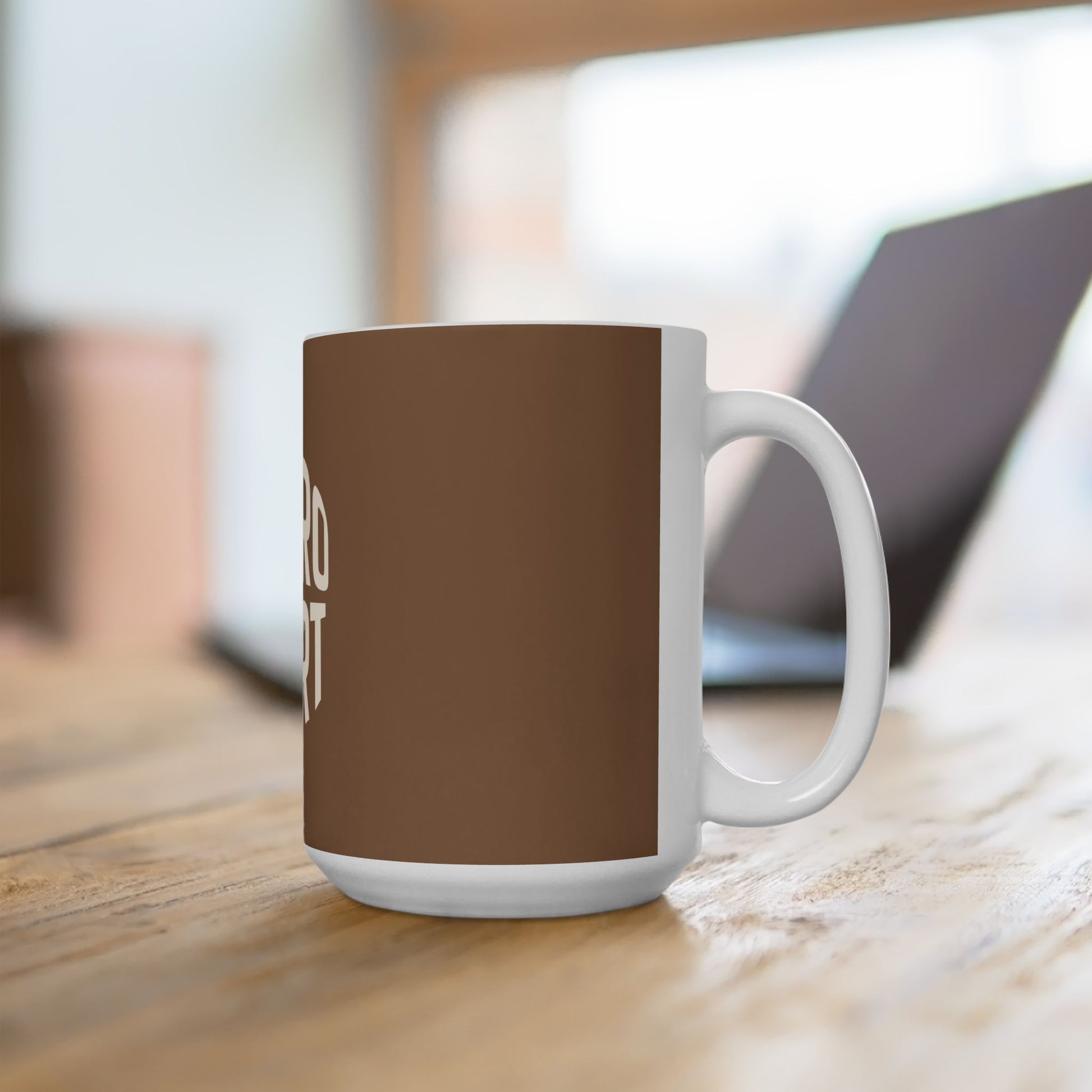 White mug with a brown accent on a wooden surface
