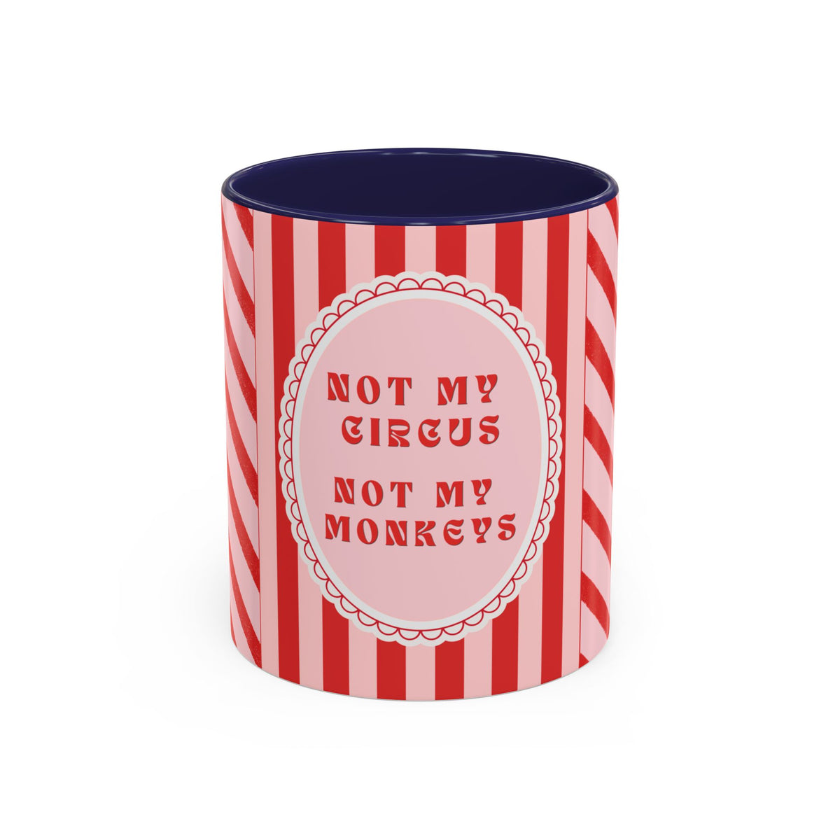 A ceramic mug with a red and pink striped design, featuring a central pink oval with the text 'NOT MY CIRCUS NOT MY MONKEYS' in red. The interior of the mug is dark navy blue.