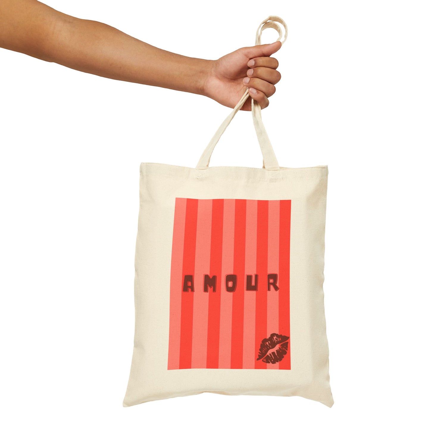 Tote bag with red striped design and 'AMOUR' text held by a hand on a white background