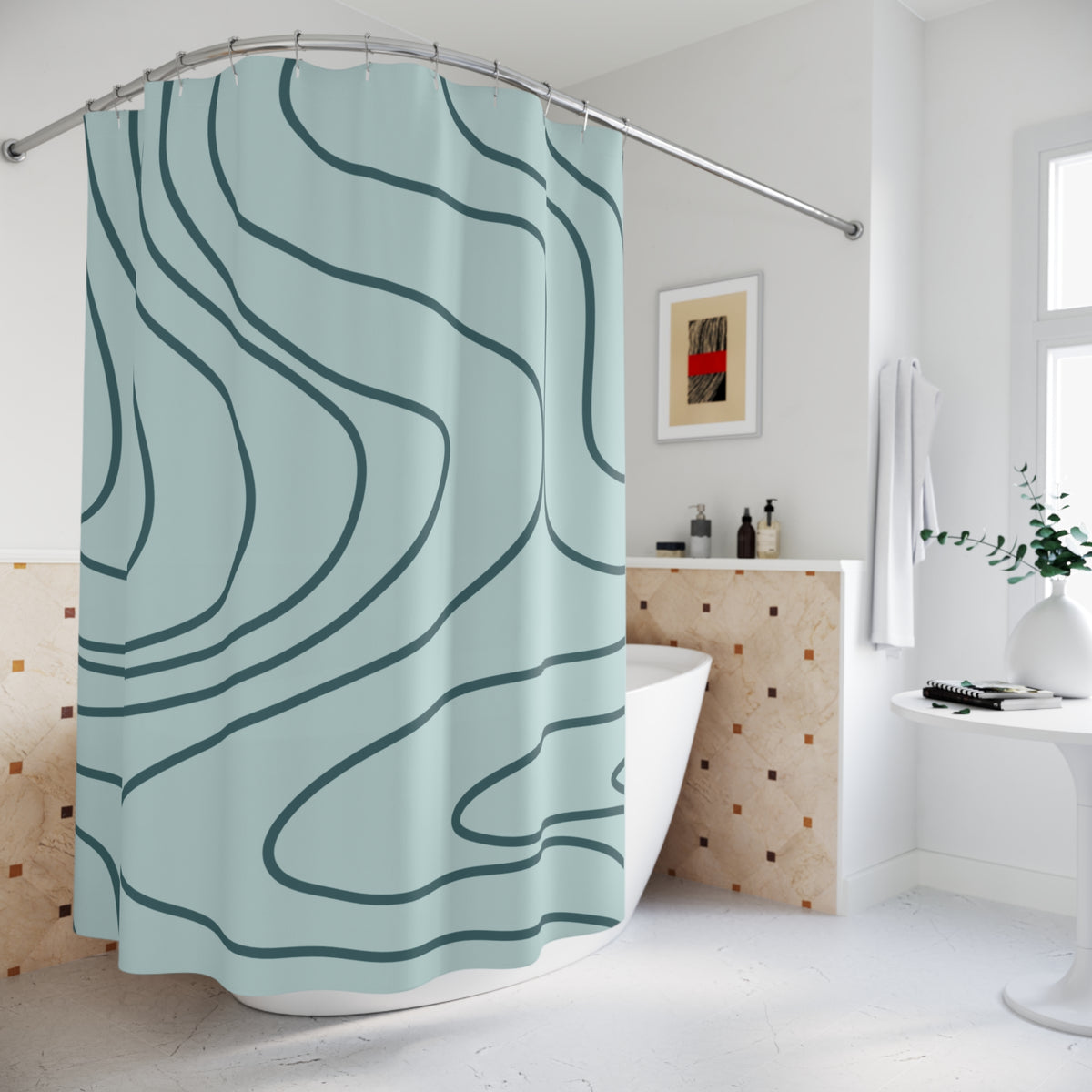 A light blue shower curtain with dark teal wavy contour-line patterns hanging in a bright, modern white bathroom.