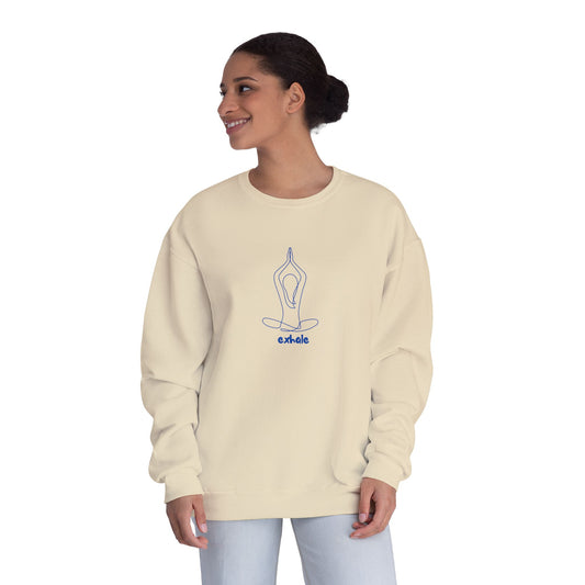 Woman wearing a beige YOGA sweatshirt with a blue design on a white background
