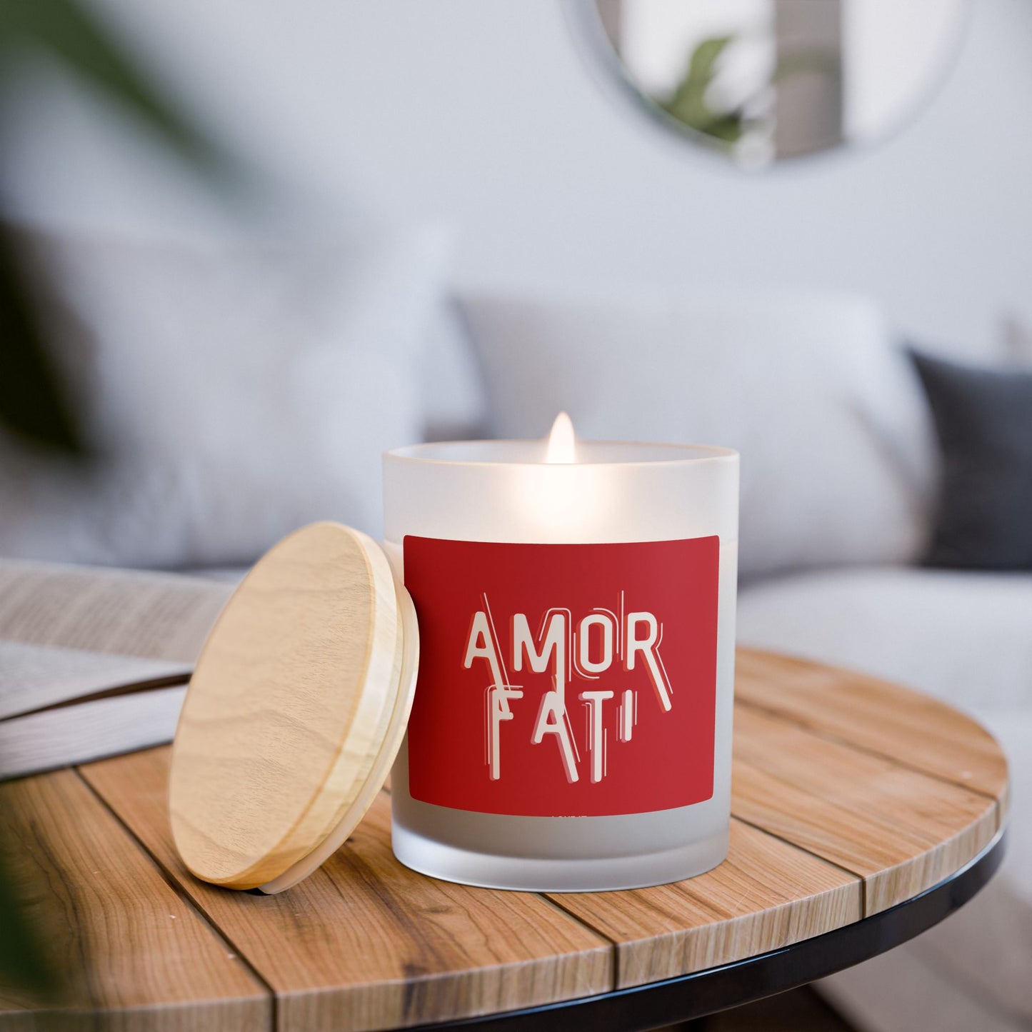 Candle with 'AMOR FATI' label on a wooden table