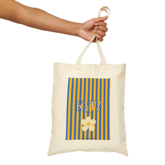 Tote bag with 'KYIV" and a flower design held by a hand on a white background