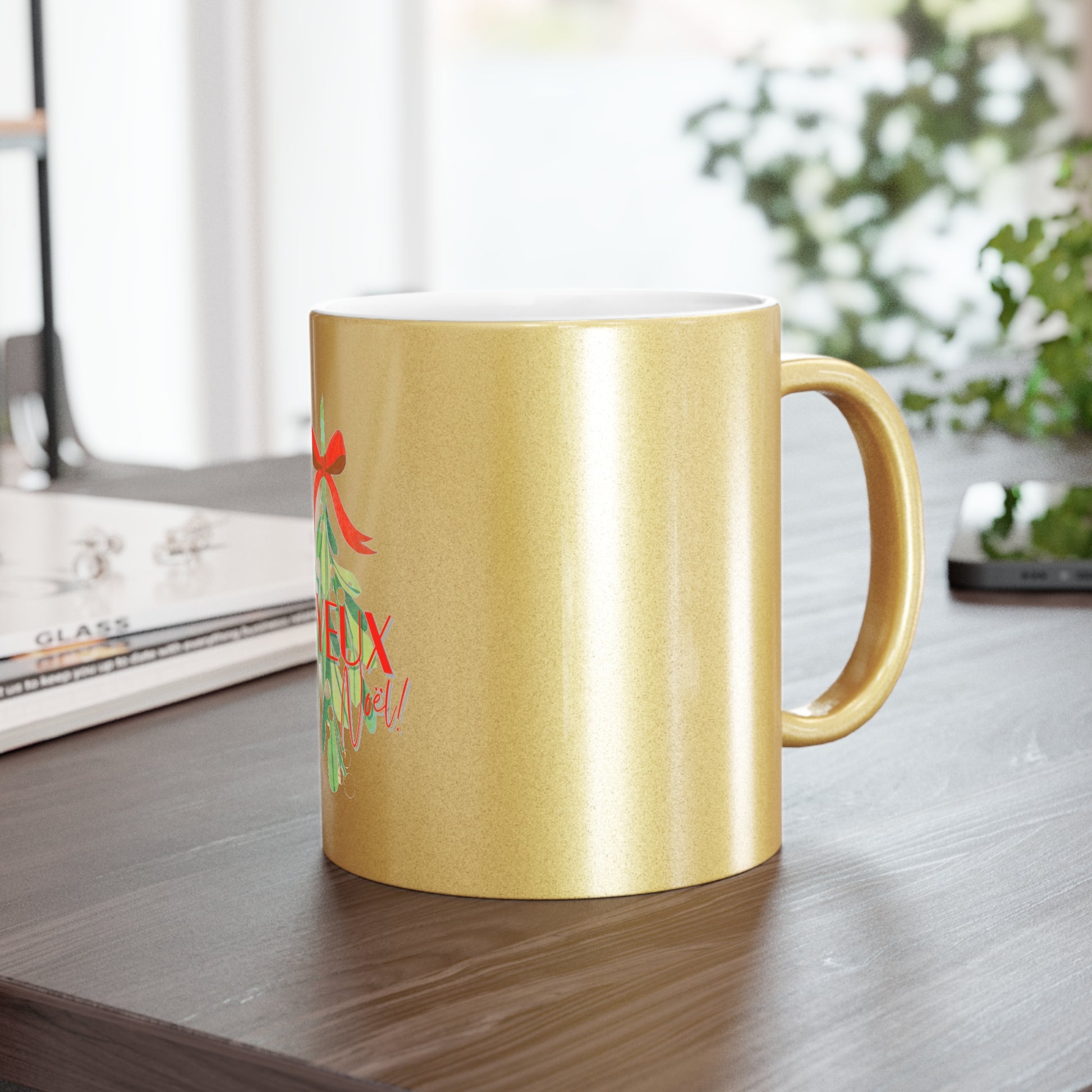 Gold mug with a design on a wooden surface