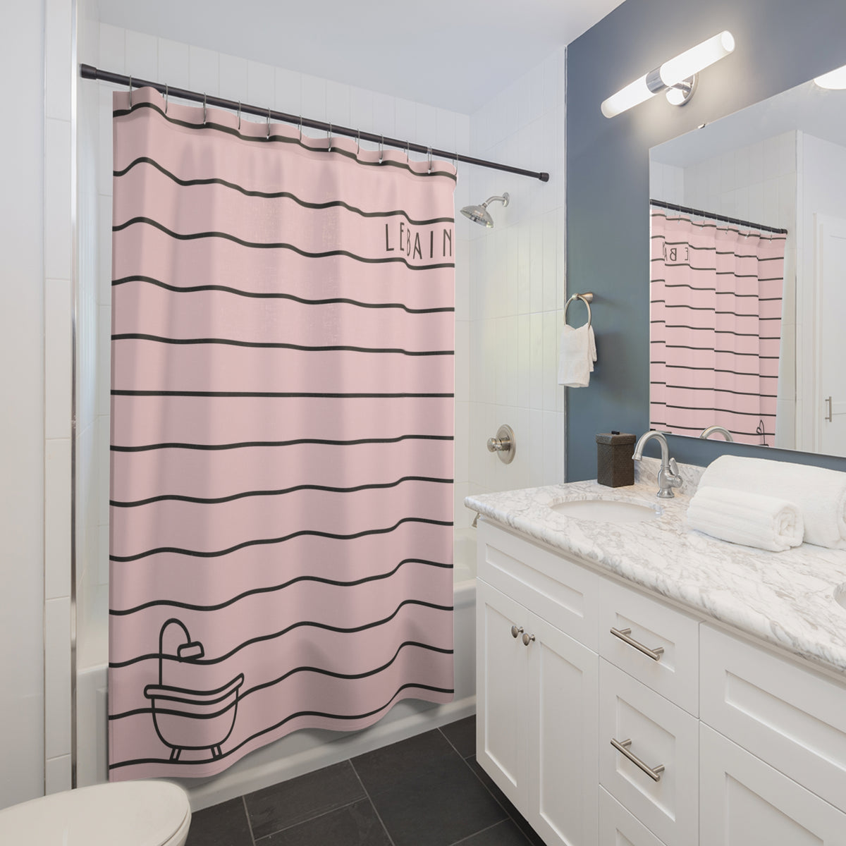 A pink shower curtain with black horizontal stripes, the word 'LISAIN' printed near the top right, and a black line drawing of a bathtub at the bottom, shown hanging in a modern bathroom next to a white vanity and mirror.