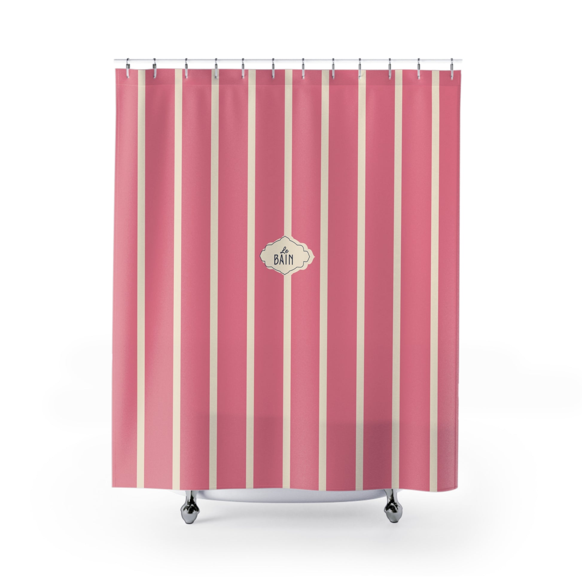 Pink shower curtain with vertical cream stripes and a central decorative label reading 'A BATH', shown hanging over a white tub against a light gray studio background.