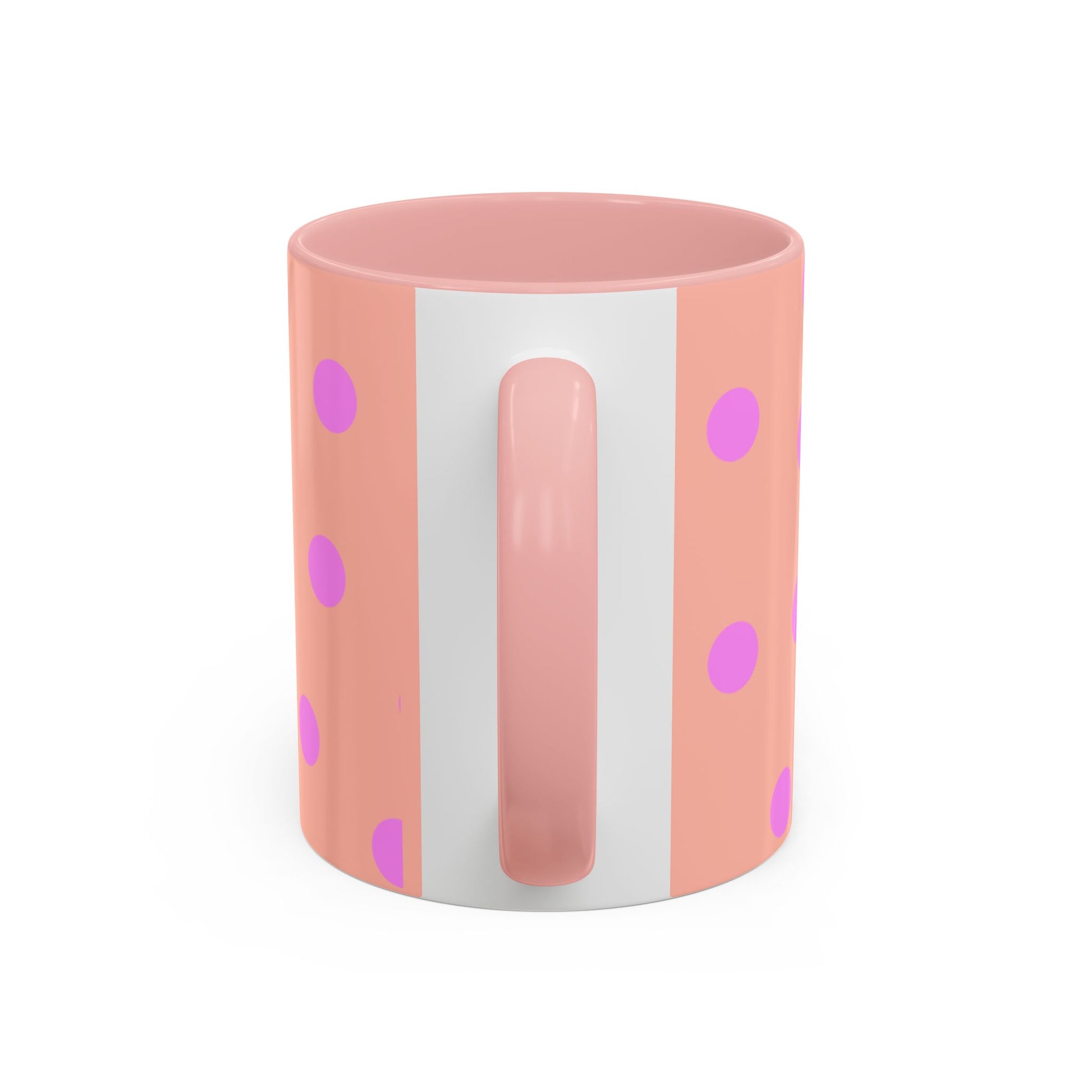 Pink mug with white handle and polka dot pattern on a white background