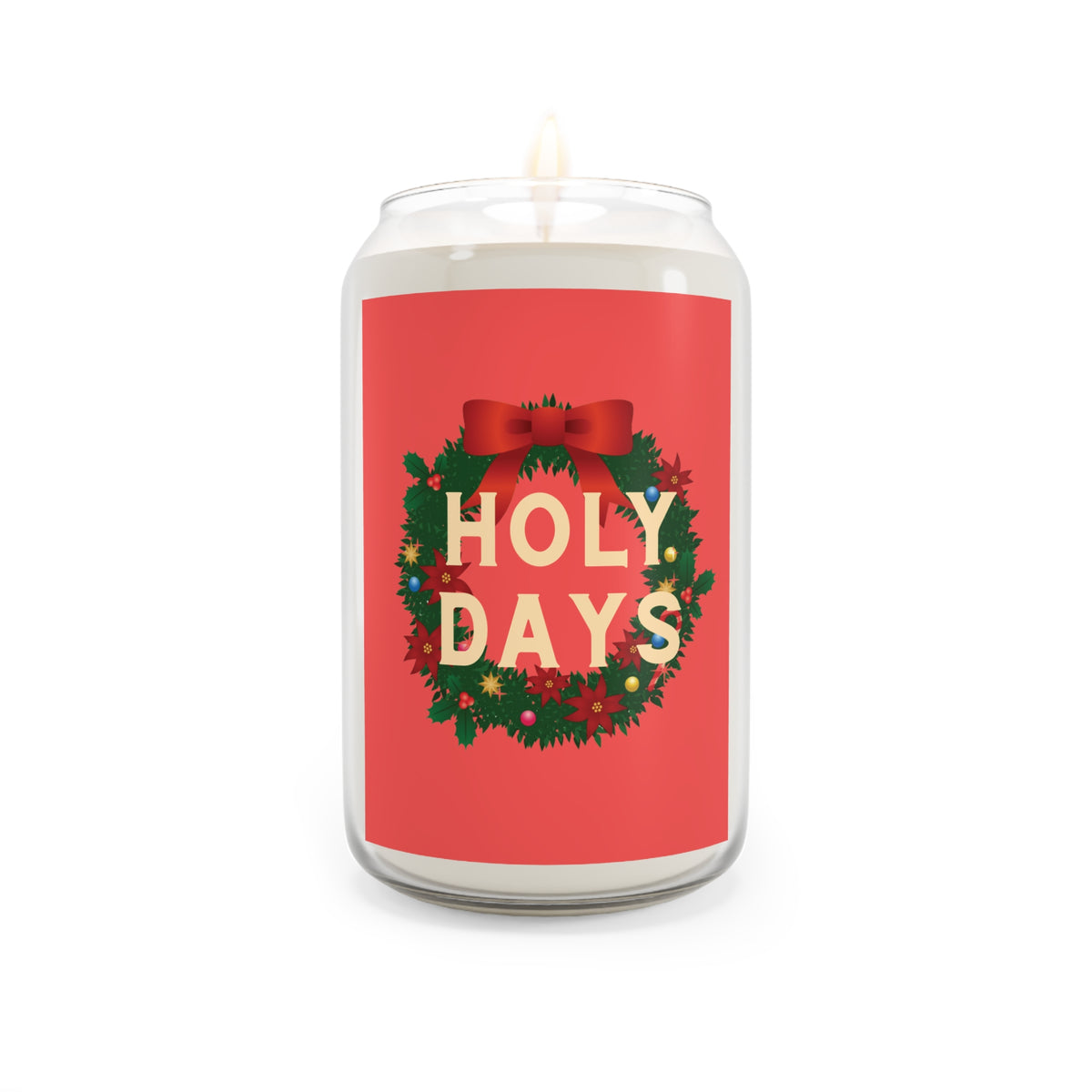 A white wax candle in a clear glass jar with a red label that reads 'HOLY DAYS' in cream letters, surrounded by a green wreath with red bow and holiday details, on a white background.