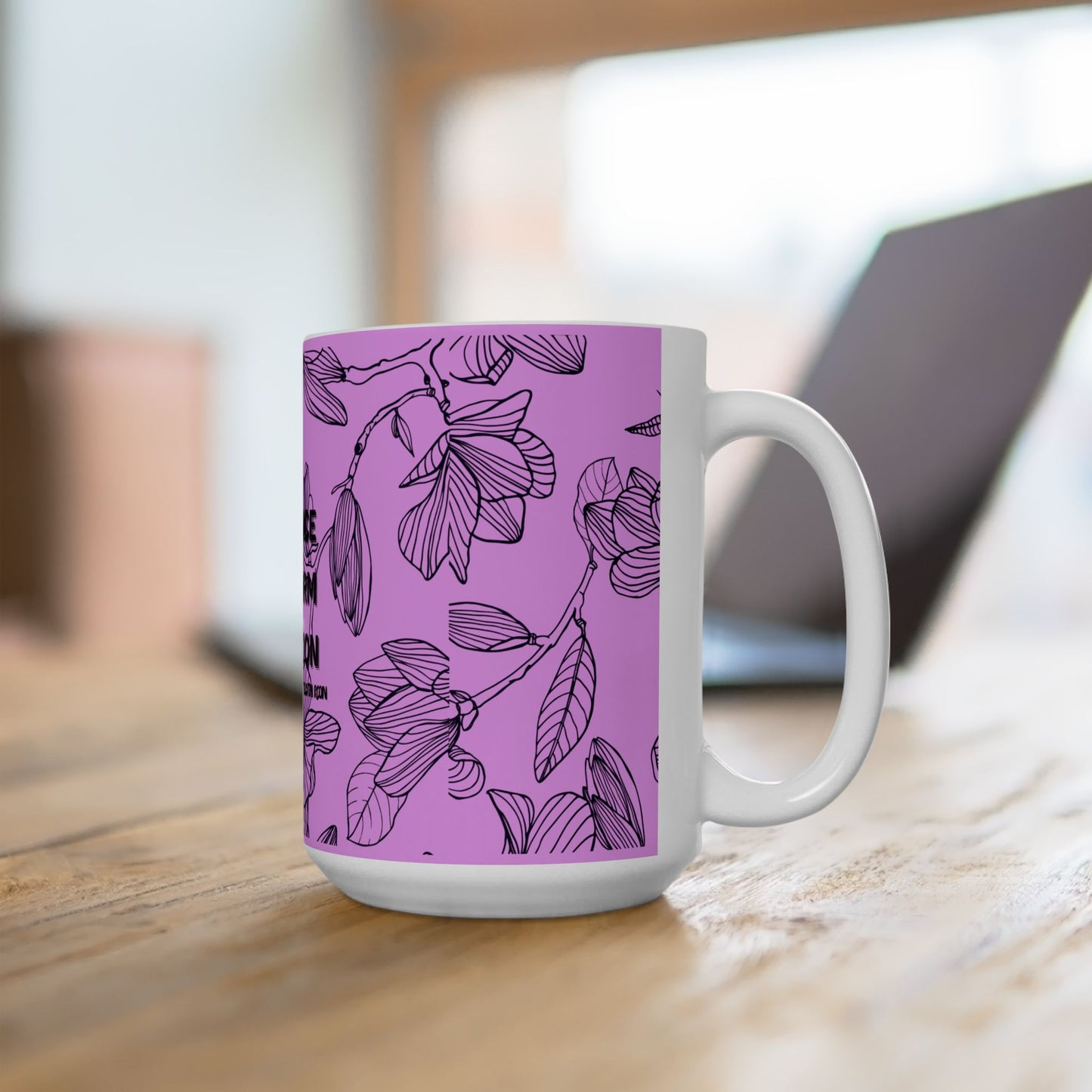White mug with a purple floral pattern on a wooden surface