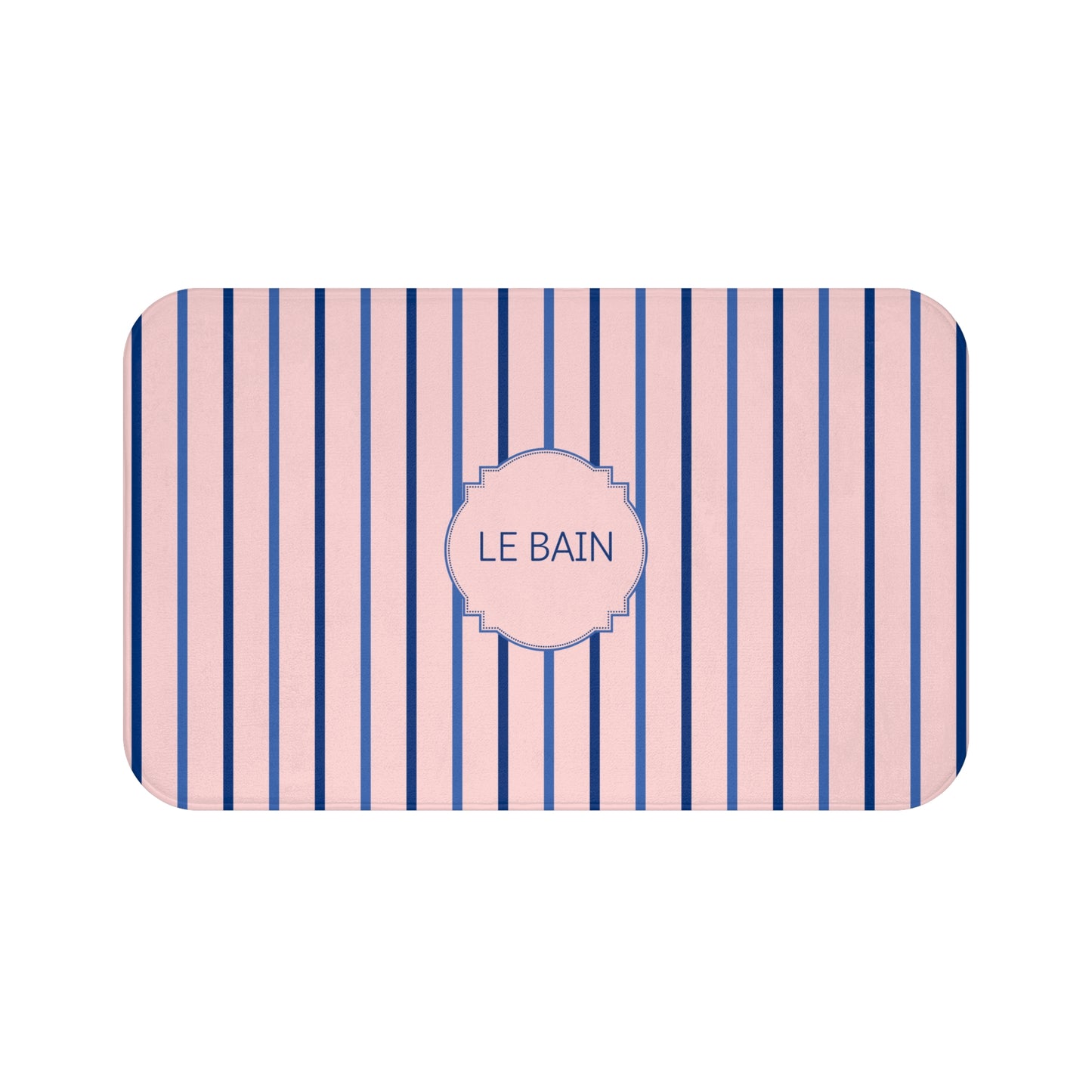 A rectangular bath mat with rounded corners, featuring vertical pink and navy blue stripes with a central pink label that reads 'LE BAIN' in navy text, shown on a plain white background.