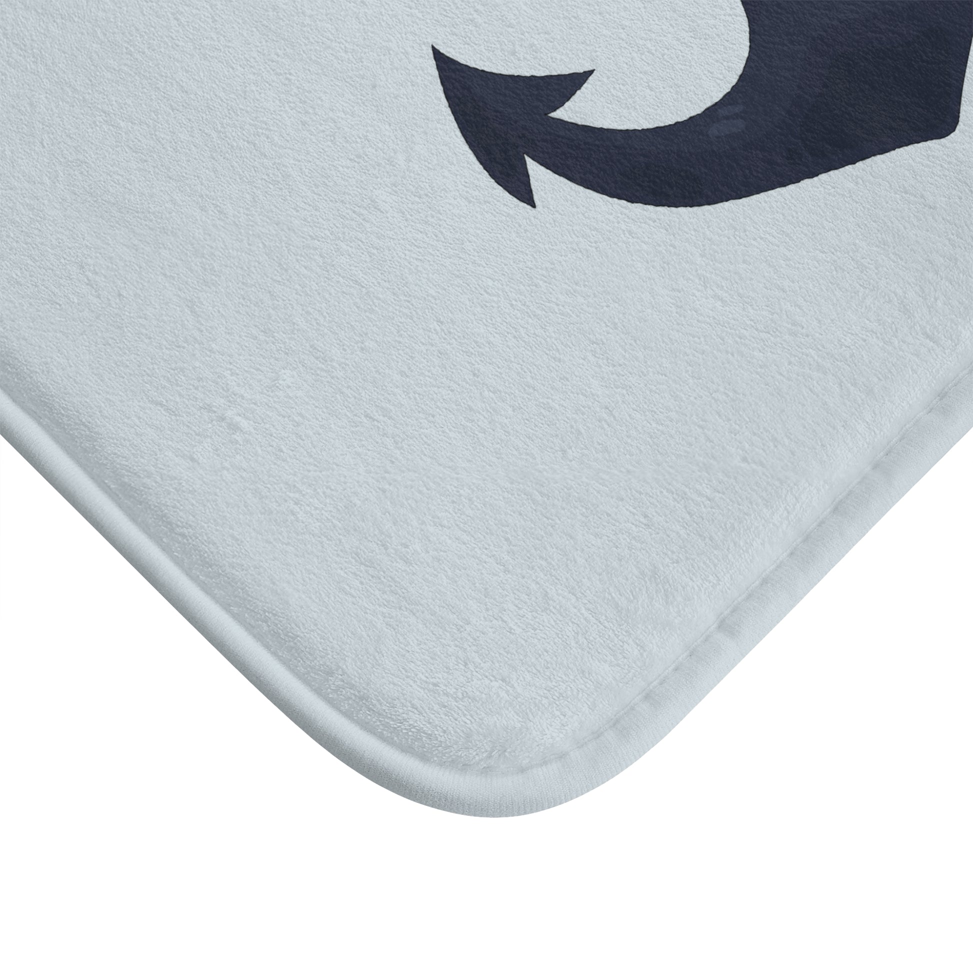 Gray bath mat with a blue arrow design on a white background