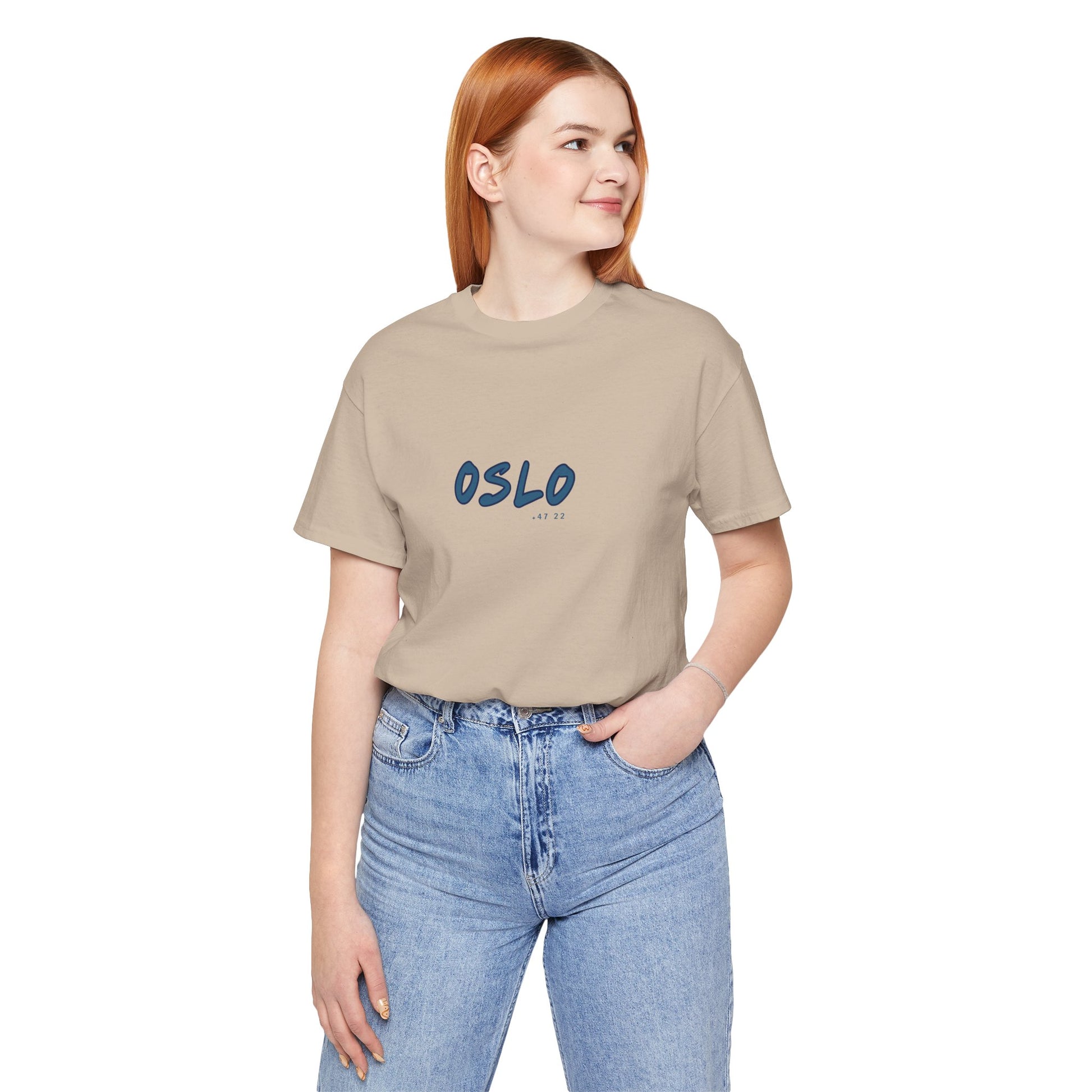 Person wearing a beige t-shirt with 'OSLO' printed on it against a white background