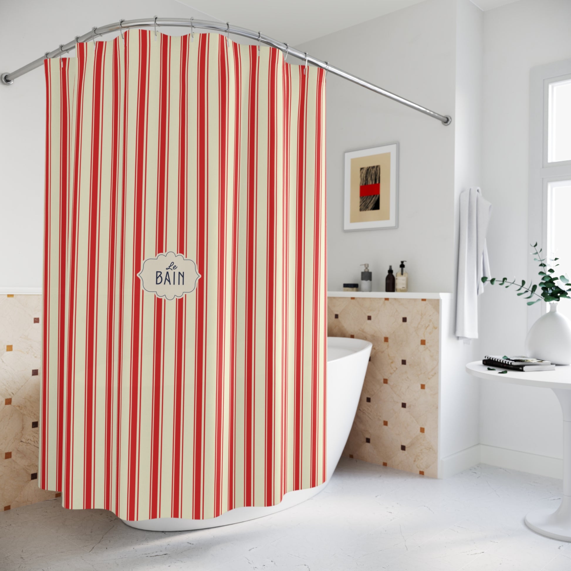 A striped fabric bathtub shower curtain hanging over a white freestanding tub in a bright bathroom. The curtain has vertical red, cream, and light beige stripes with a central white label reading “A BATH.