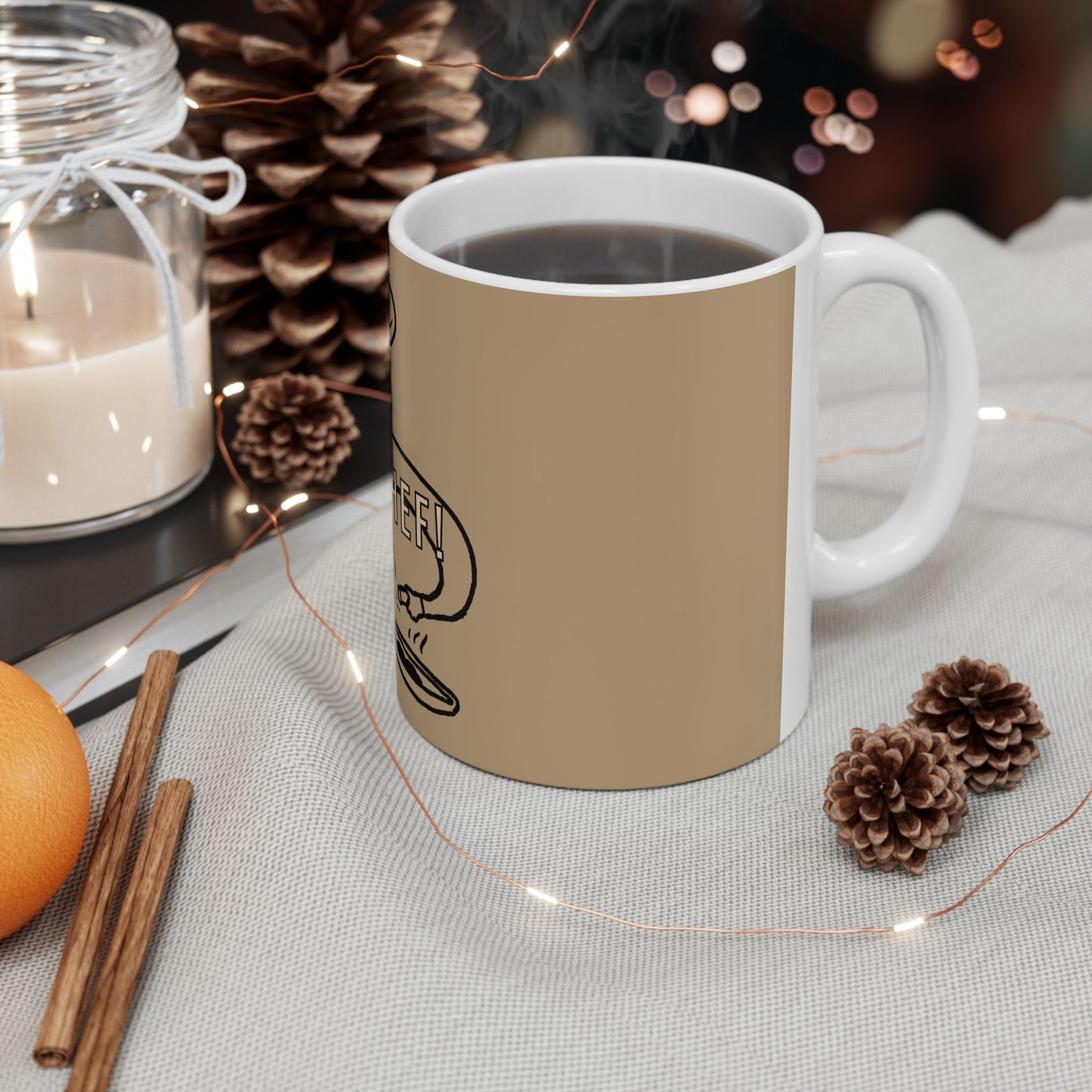 White mug with red floral pattern on a table with decorative items