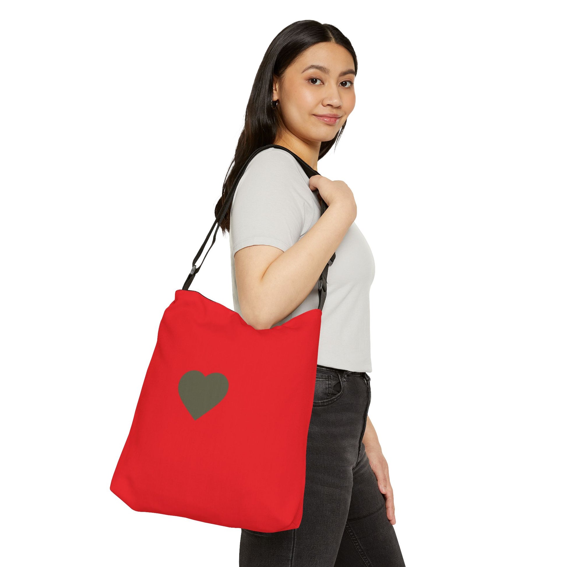 Woman holding a red tote bag with a heart design on a white background