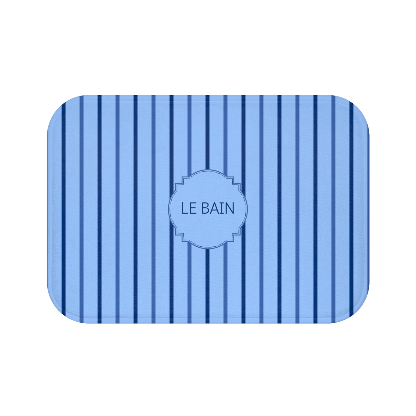 A rectangular bath mat with rounded corners, featuring a light blue and navy blue vertical stripe pattern and a central decorative label that reads 'LE BAIN'.