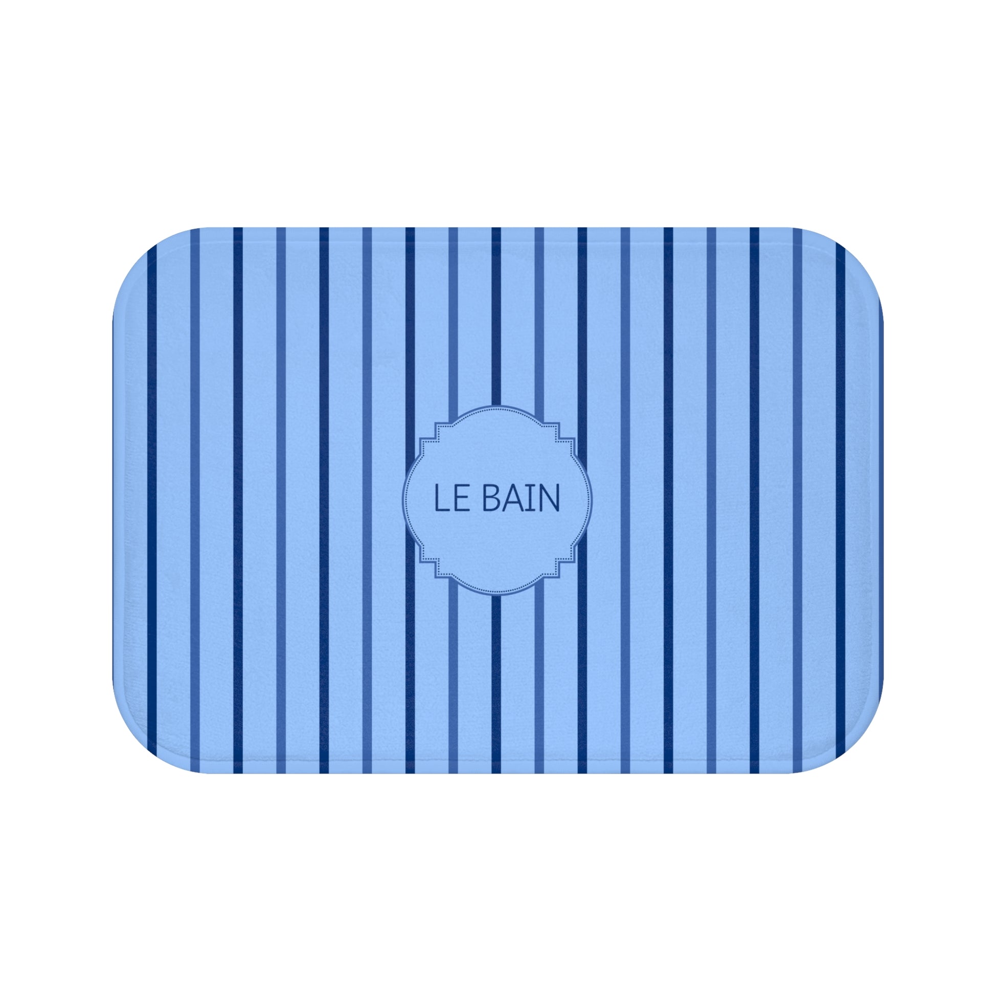 A rectangular bath mat with rounded corners, featuring a light blue and navy blue vertical stripe pattern and a central decorative label that reads 'LE BAIN'.