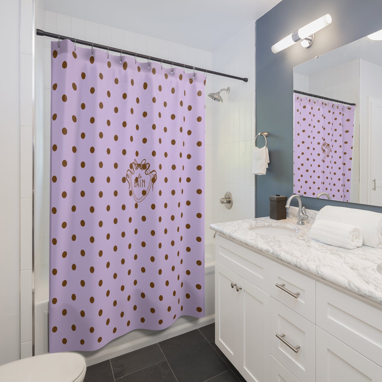 Bathroom with a lilac shower curtain with gold polka dots and a white vanity.