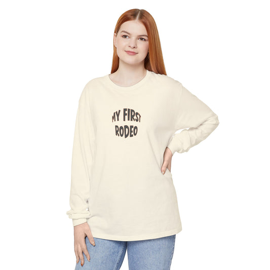 Woman wearing a cream-colored sweatshirt with 'My First Rodeo' text on a white background