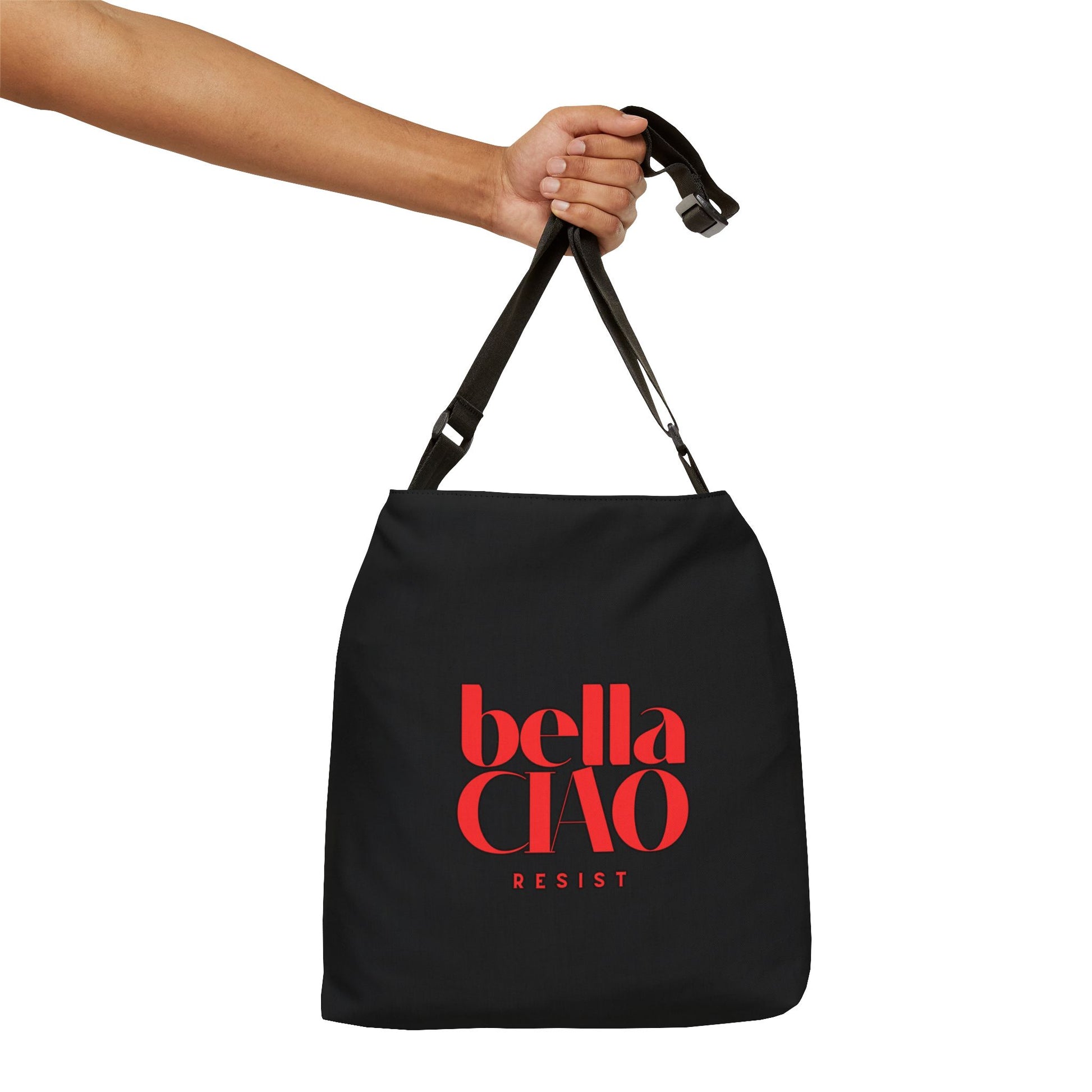 Black bag with 'bella CIAO RESIST' text held by a hand on a white background