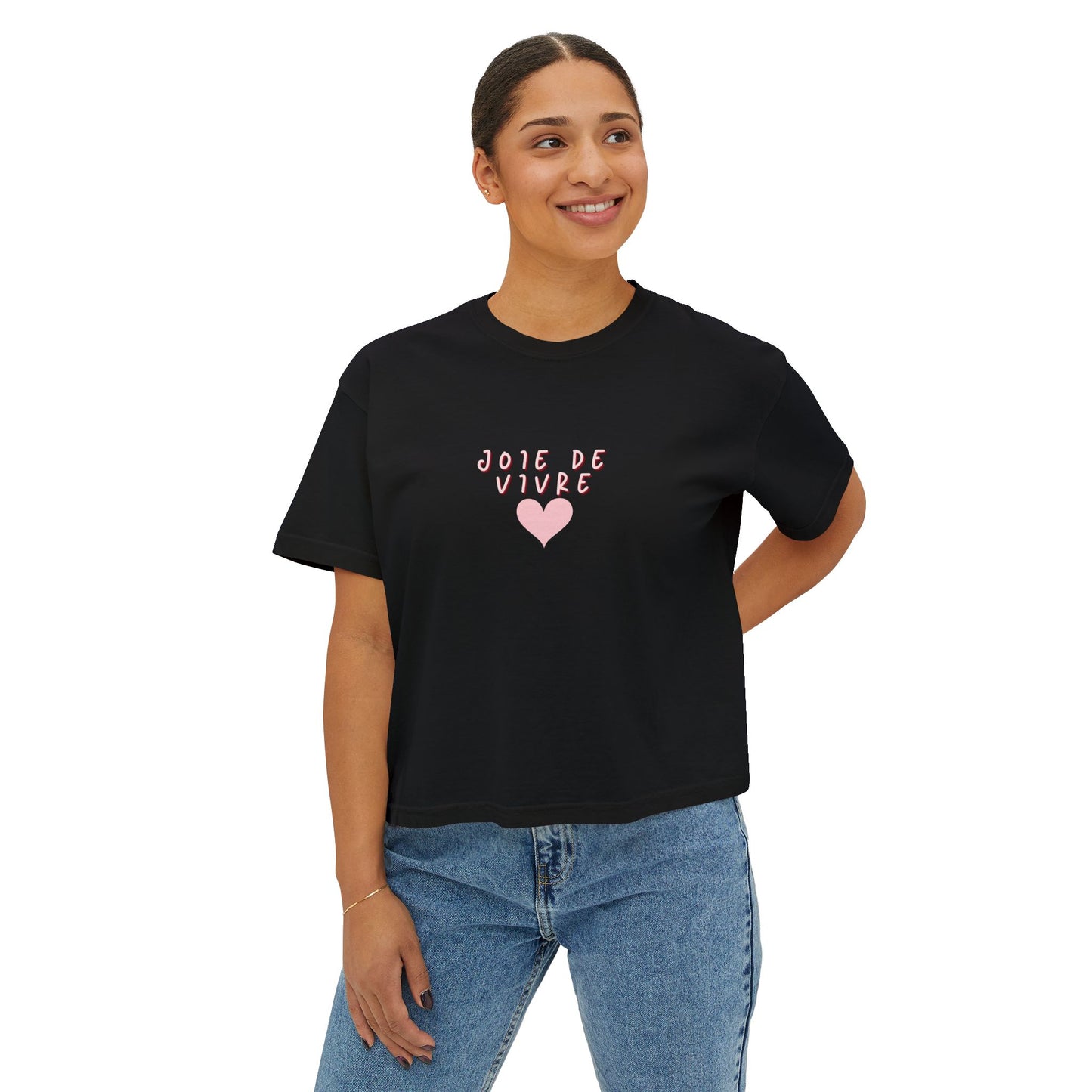 Person wearing a black t-shirt with 'Joie de Vivre' text and heart design on a white background