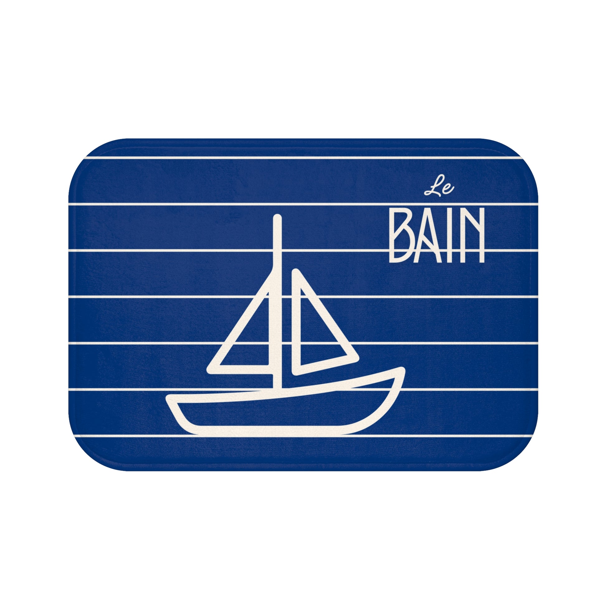 Blue bathroom rug with white sailboat illustration and 'Le Bain' text on a white background