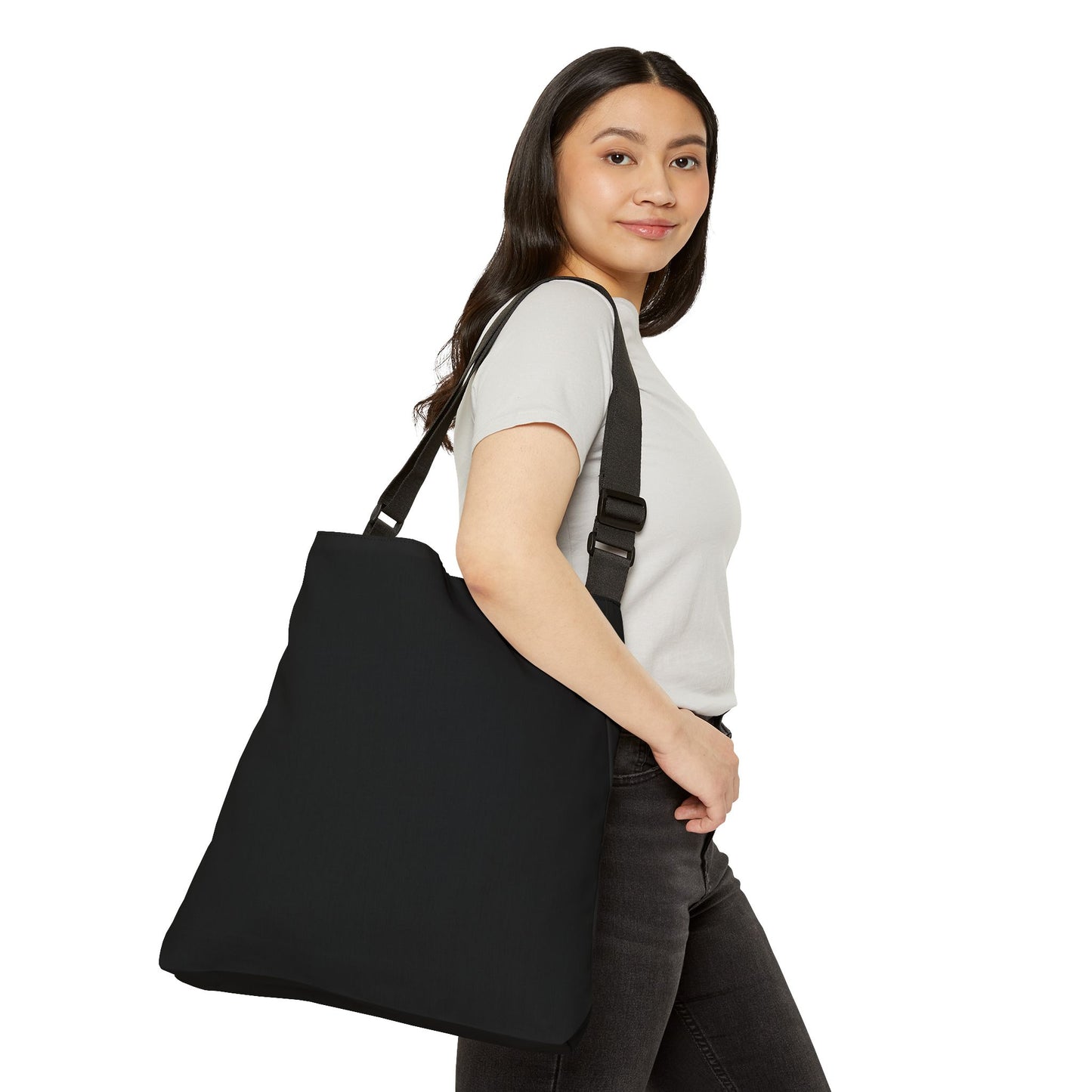 Woman carrying a black tote bag on a white background