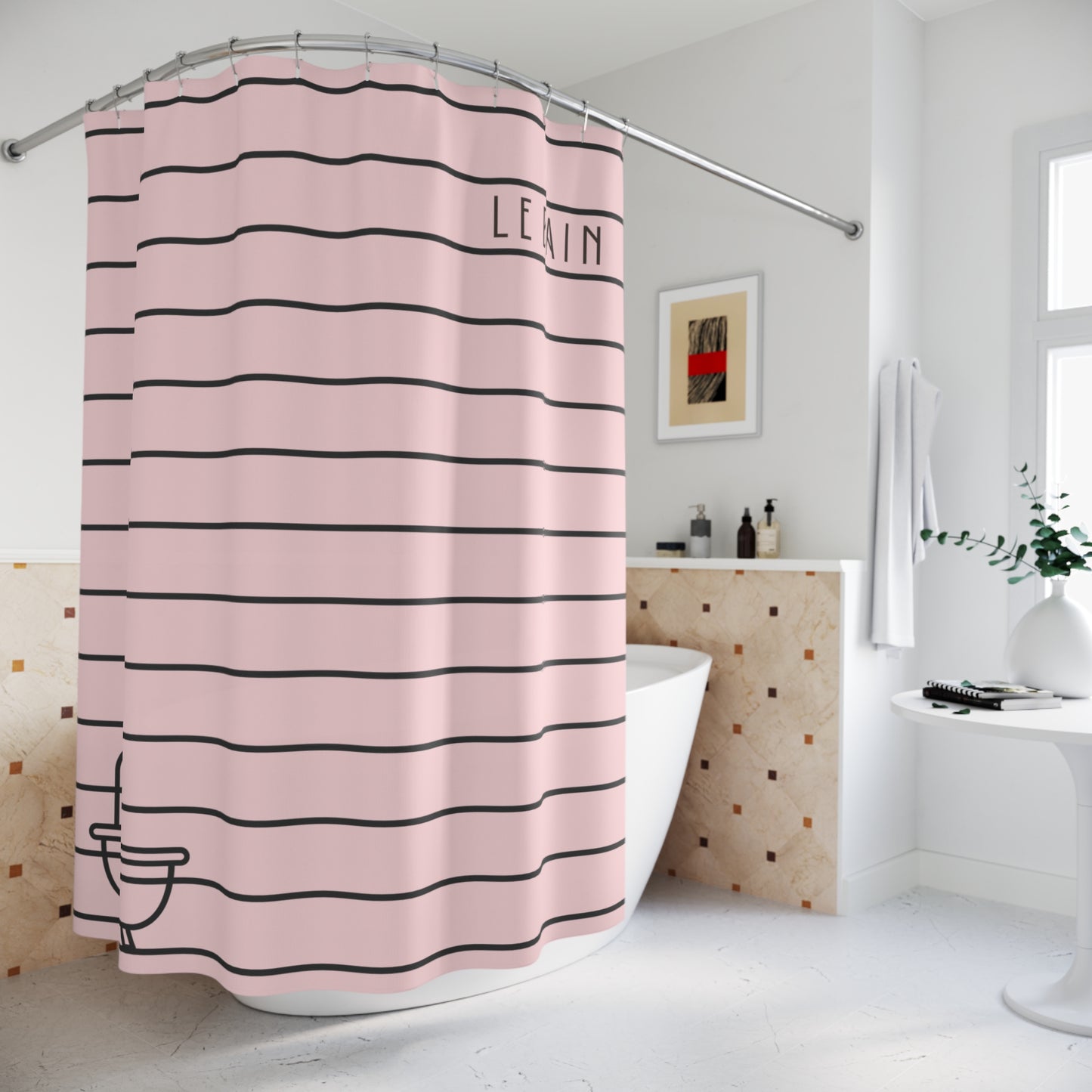 A pink shower curtain with horizontal black stripes and the word 'LEVIN' printed near the top right, hanging in a bright white bathroom next to a bathtub.