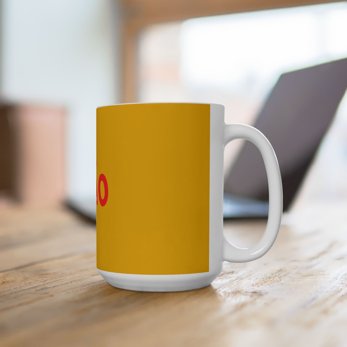 Yellow mug with a white handle on a wooden surface