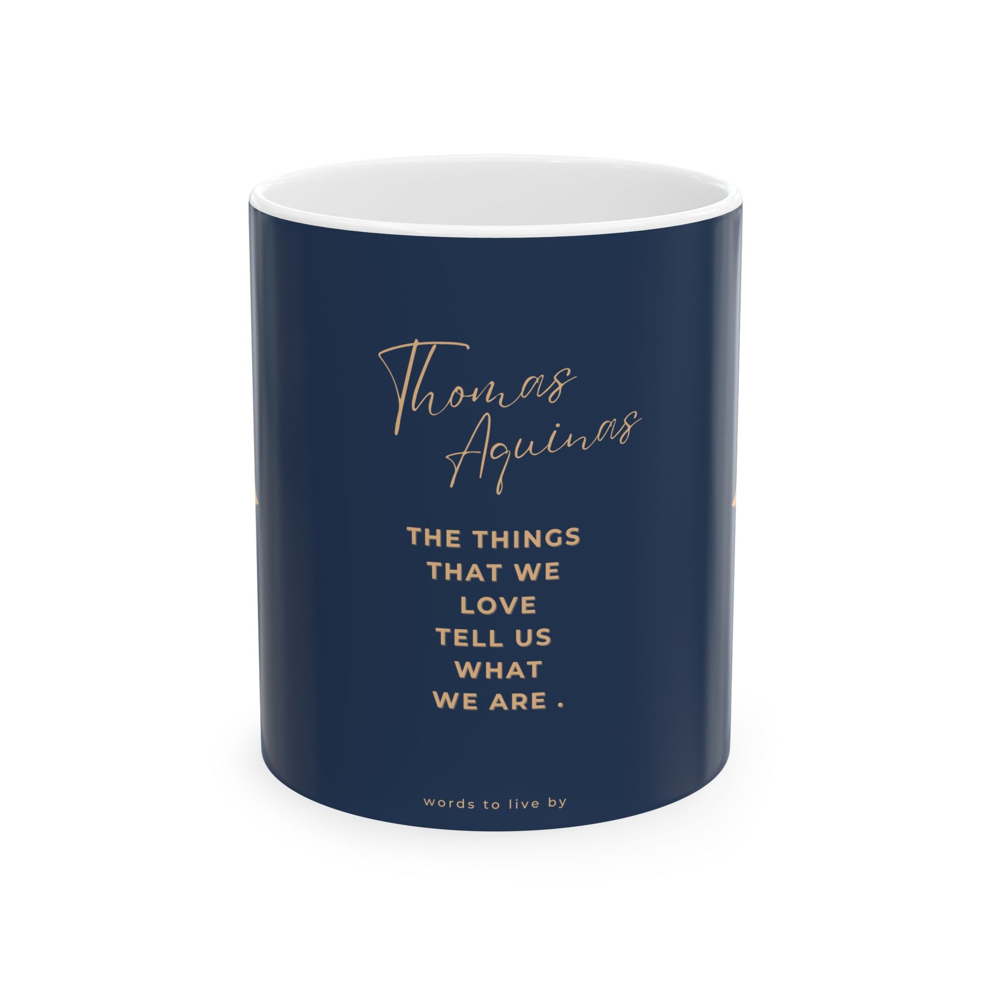Navy mug with white interior and gold text featuring a quote by Thomas Aquinas on a white background