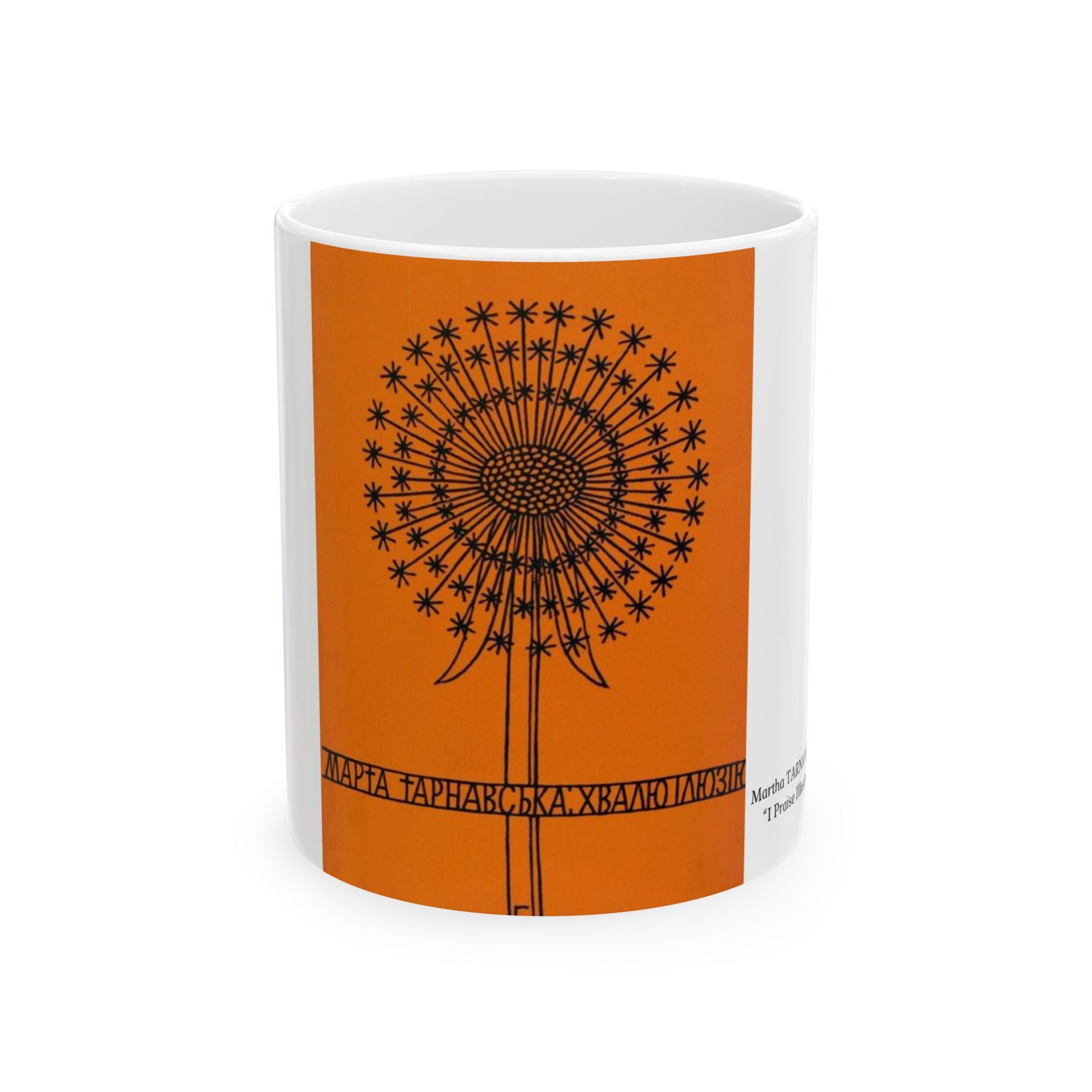 White mug with an orange design featuring a black dandelion-like pattern on a white background