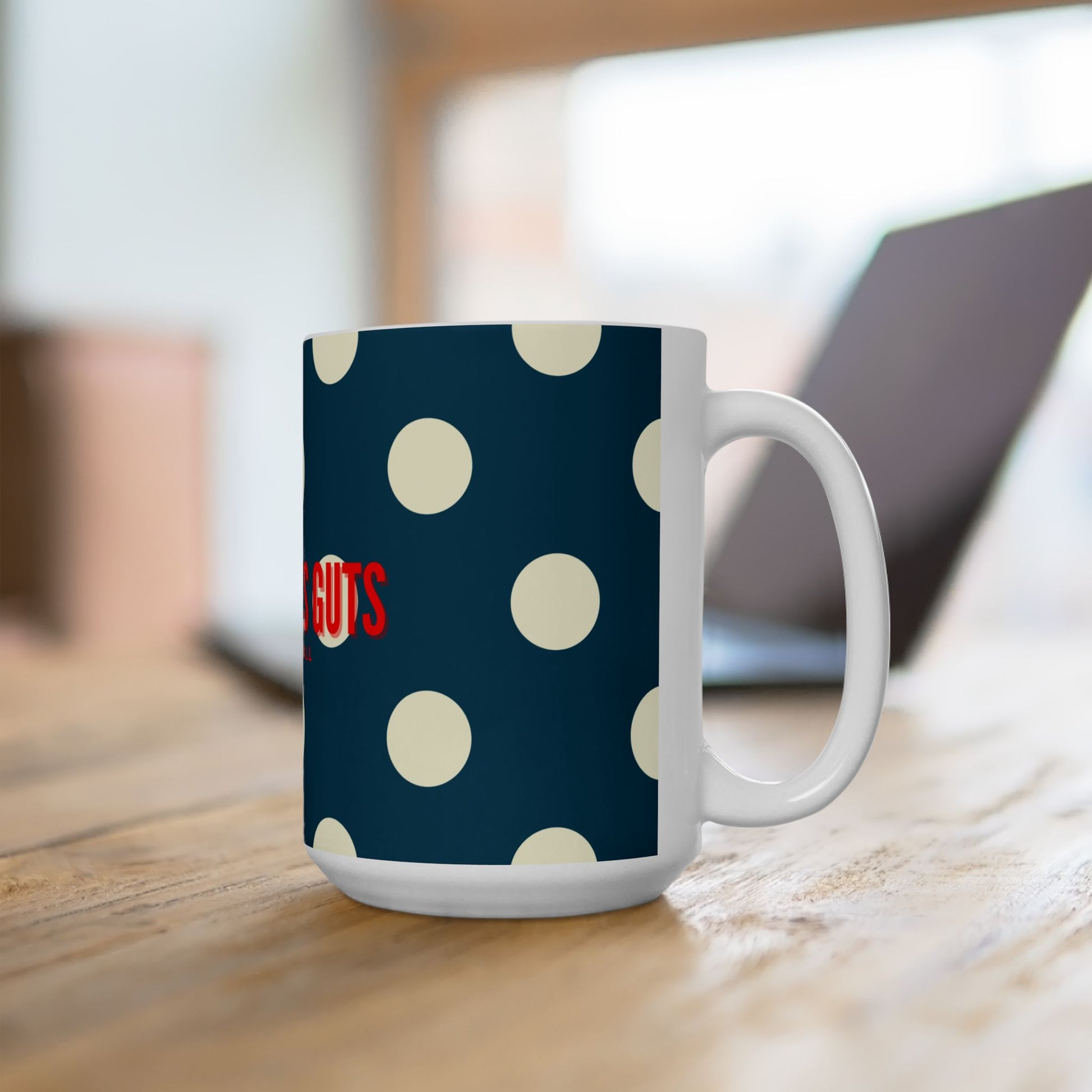 Mug with polka dot design and visible text on a wooden surface