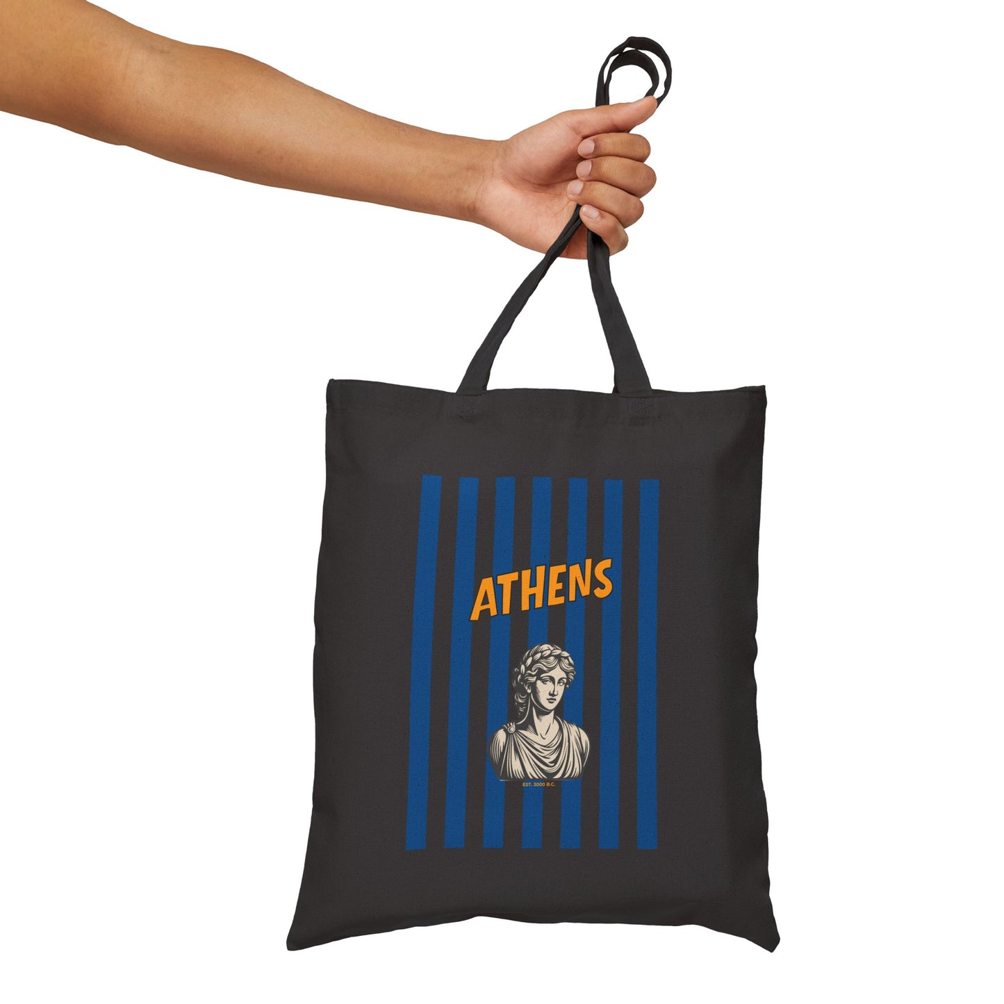 Black tote bag with 'Athens' design held by a hand on a white background