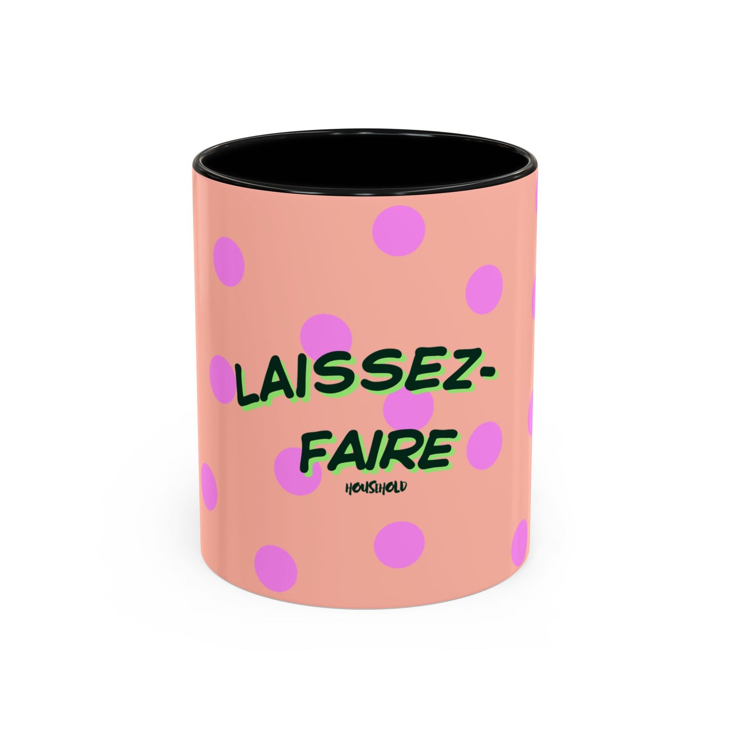 Pink mug with polka dots and green text on a white background