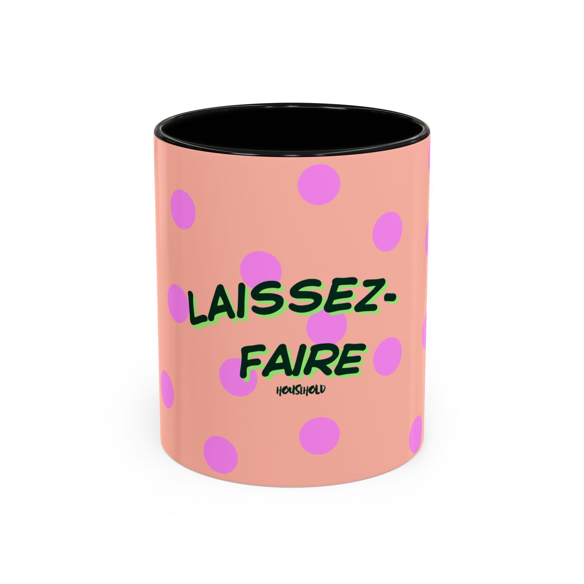 Pink mug with polka dots and green text on a white background