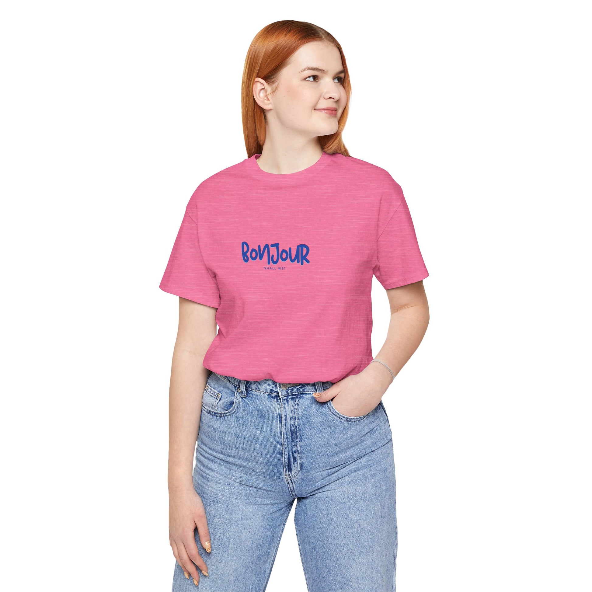 Person wearing a pink t-shirt with 'Bonjour' text on a white background